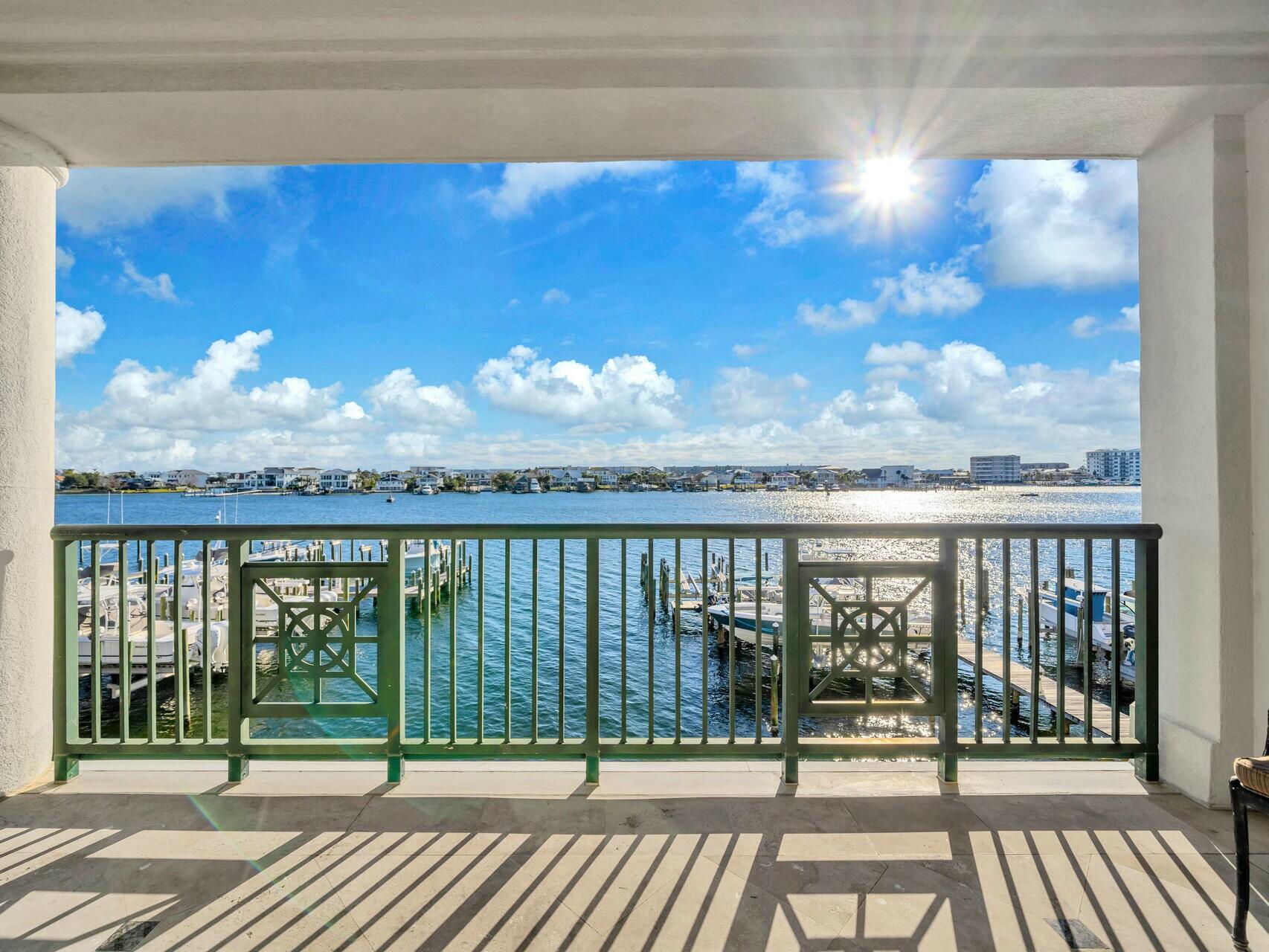 The ultimate haven for boating enthusiasts! This elegantly designed 3BR/ 3BA condo located at Tranquil Harbor is perched on a bluff overlooking the Destin Harbor combines luxury, serenity, and functionalityThis condo comes with a deeded slip featuring a recently installed 20,000lb boat lift, a custom-built large cleaning table, and the ability to accommodate a 36' to 40' boat--one of the few properties on the Destin Harbor with such a capability. Equipped with a full electrical pedestal, water hookup, and a remote control to operate the lift from inside your boat. From the moment you step inside, you're greeted by breathtaking harbor views that flow seamlessly into an open floor plan, bathing the space in natural light through corner windows facing east and south.
