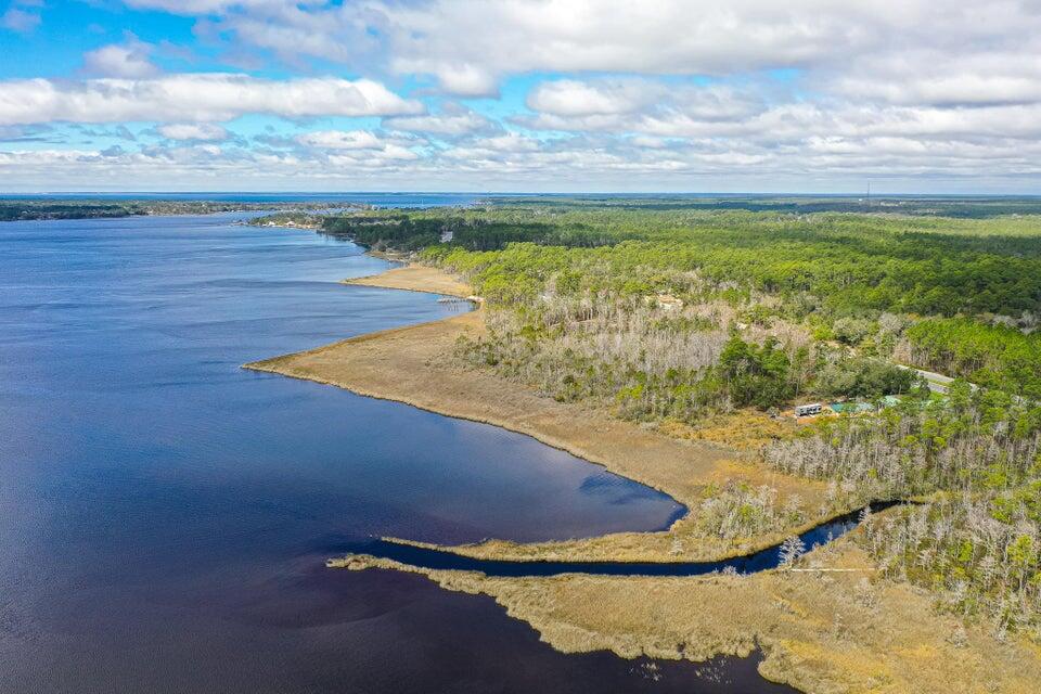 ***Rare 7 ACRES on the water!*** Have you ever dreamed of living on the water? Here is your opportunity to own 8 ACRES on the Bay! Approximately 469 Feet of waterfront. Build your own estate! Room to roam! No HOA so you can do whatever your heart desires! What could be better than fishing from your own backyard? Put out a crab trap. Watch the Sunset with your favorite beverage. Kayak, Boat, Paddleboard, Swim... the options are endless! City water and utilities available out front. Currently wooded with beautiful natural hardwoods and pine. Just minutes drive to Navarre Beach, shopping and restaurants. About 30 minutes drive to Hurlburt Field.