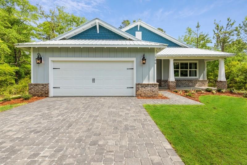 Beautiful new construction home! From the hints of shiplap, stained pine tongue and groove in the tray ceilings and on the porches, to the beautiful ceramic tile throughout you will be impressed with the builder's design choices. The incredible kitchen is equipped with stainless steel in-cabinet microwave and oven, an induction cooktop, stunning granite countertops, tile backsplash and large pantry. The entire home has nine foot ceilings and eight foot doors. The master is an absolute dream with an impressive en-suite bathroom and huge his and her closets. You'll never have to argue over closet space again! Other features include an office, oversized laundry room with mudroom area, a wet bar and an oversized two car garage. Buyer to verify any and all information deemed important to them.
