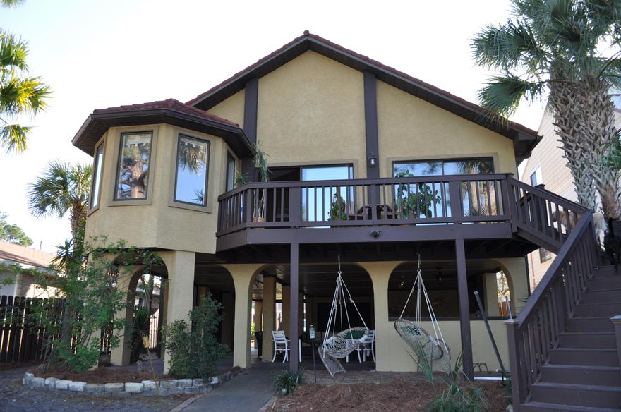 Mediterranean waterfront retreat and tropical paradise all in one home! This lagoon front home has been completely remodeled by the current owner and meticulously maintained as his personal residence. For the most discerning buyer, this property boasts 4,444 total square feet with 2,196 heated and cooled, 50 feet of waterfront with completely refurbished dock, 360 linear feet of 6 foot fencing, GTO Pro Gate Operator for security and privacy, ample garage parking, 20 palm trees, and lemon, orange and grapefruit trees, custom exterior hurricane shutters. Tung in groove mahogany hardwood floors grace the living areas and bedrooms while 20 inch tile was strategically placed in the bathrooms and kitchen.