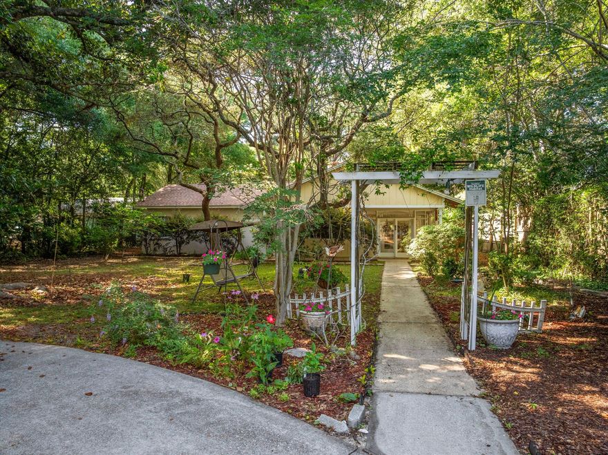 Charming Nature Retreat in Fort Walton Beach *** Discover serenity in this beautifully unique home, nestled on a spacious 0.48-acre Certified Wildlife Habitat lot.  Surrounded by mature trees, lush gardens, and vibrant wildlife, this 3-bedroom, 2-bath retreat offers vintage charm with some modern updates--all conveniently located to military bases, shopping, restaurants, schools, medical, and beautiful beaches. *** A circular driveway leads to a welcoming arbor-covered walkway and a covered front porch with exposed beams. Inside, the Florida room is bathed in natural light--perfect for relaxing or entertaining. The spacious living and family rooms provide inviting spaces, including a cozy wood-burning fireplace.  The kitchen, with warm wood cabinetry and exposed brick, opens to a bright dining area with parquet floor and backyard views. Step outside to enjocovered porch, an open patio, greenhouse, storage shed, and flourishing gardens featuring live oaks, herbs, flowers, and fruit-bearing plants.***Recent updates and features include: new roof (2021), water heater (2018).  A transferable home warranty is in place.  In addition, the home is equipped with copper wiring and has undergone a 4-point inspection (August 2024) and wind mitigation assessment (August 2023), with reports available upon request.***Original brick wood-burning fireplace, 4x4 tilework in bathrooms and timeless details throughout make this home truly special. A rare blend of charm, space, and nature in the heart of Fort Walton Beach. *** Schedule your showing today to experience this hidden gem. *** Buyer is responsible for verifying all data and information including lot size and room measurements as it is deemed to be reliable but not guaranteed.
