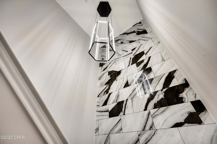 This marvelously upgraded Island Reserve unit has one of the most unique and desirable layouts on the beach! It boasts 1588 sq. ft. of open & spacious living space, spread over 2 floors with stunning 10-foot ceilings, updated bathrooms, and incredible marble tile. Do you like outdoor living? There are TWO private balconies, one from the main living area and another off of the primary bedroom.  This unit also features an oversized storage area that is being used as an office/sleeping quarter. The Island Reserve Resort Community is remarkable! It truly feels as if you've been transported to another place. From the courtyards with fountains and lush landscaping, to the sprawling one acre resort-style lagoon pool with rock waterfall, this gated community has it all!