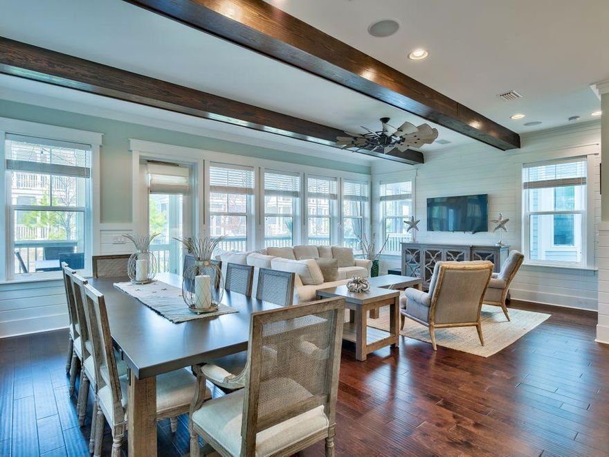 Those looking for both beauty and added value will appreciate this fully-furnished home in the 155-acre NatureWalk community at Seagrove. Surrounded by natural preserve, this home is in a prime park location and includes over $120,000 in design selection upgrades, furnishings and even includes an eco-friendly golf cart. Dark wood floors enhance the huge open living room with its beamed ceiling, wall of windows and calm coastal-inspired decor. The open concept plan includes chef's kitchen, dining table for 10, an office nook that open onto a lovely screened front porch. The kitchen has stainless appliances, glass cabinetry, quartz countertops and an island breakfast bar.