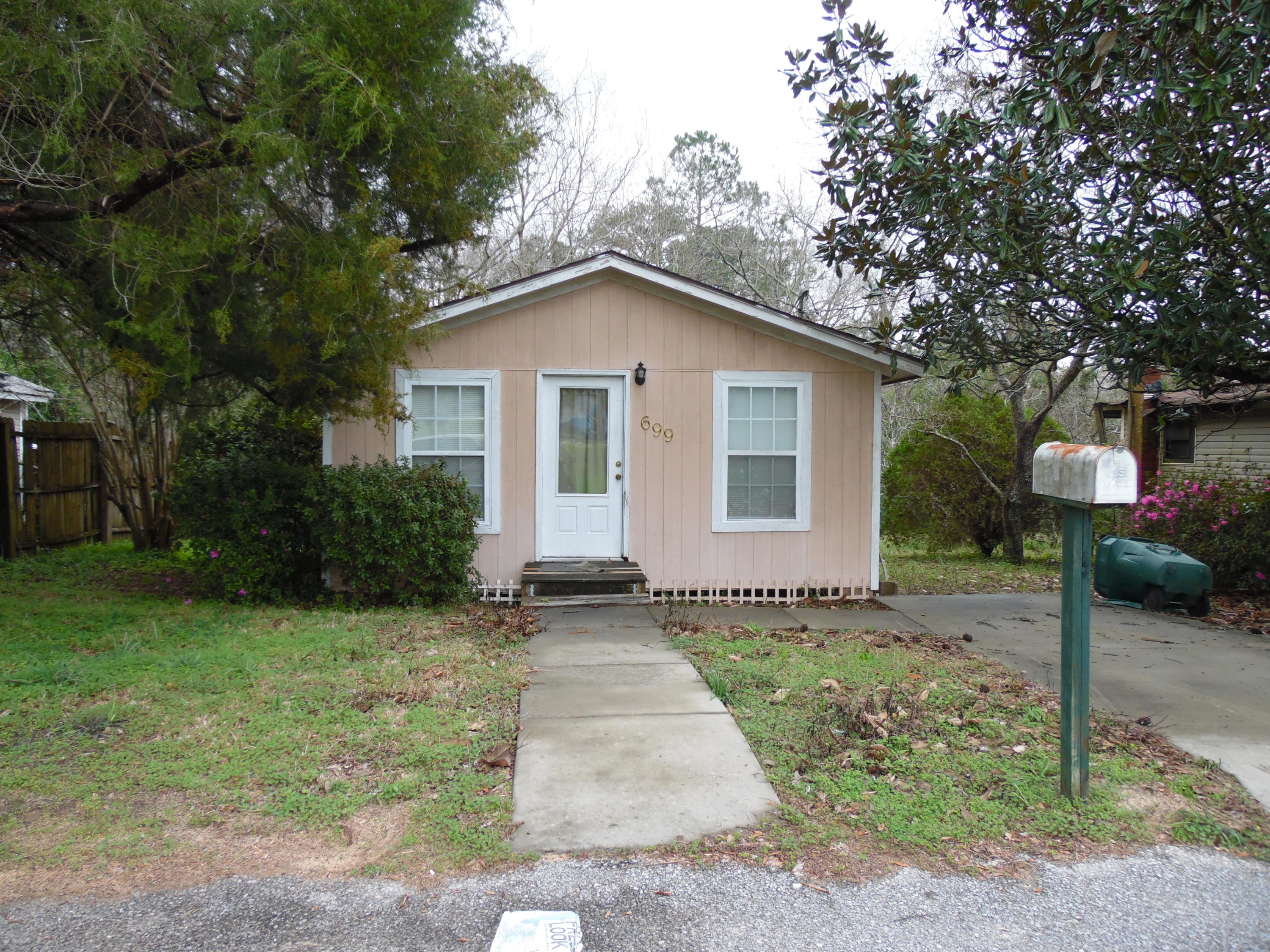 Perfect home built in 1960 for couple or single person. Home was updated some years ago with ceramic tile floors and beautiful refinished pinewood floors and vinyl siding, has open back deck. Really set up for a 1 bedroom, but there is another room that could be used for a second bedroom. Stove and refrigerator, washer and new hot water heater convey. There is another house on the property, but it is only used for storage, not livable. Home is being sold AS IS.