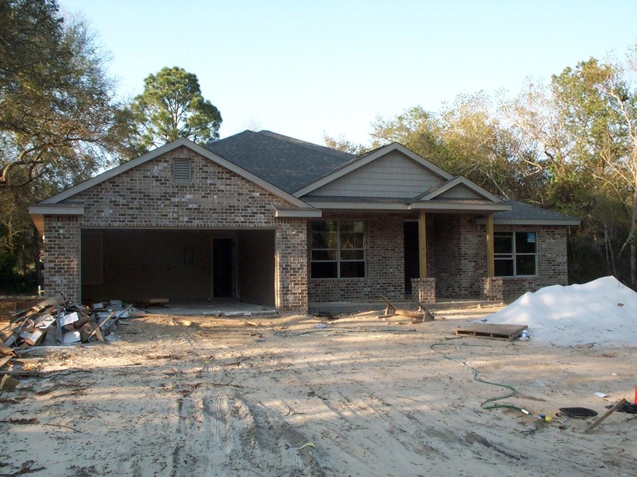BEAUTIFUL BRAND NEW ALL BRICK ONE STORY. Huge lot with privacy fence. Less than 1/2 block from Choctawhatchee Bay. Not in a flood zone. Stunning mahogany wood look porcelain tile thru out, except for guest bedrooms. Stunning upgraded kitchen cabinets contract beautifully with stainless steel kitchen and granite tops. Treyed ceilings in the dining room, living room and master bedroom providing additional ceiling height. All bedrooms have return air ducts creating balanced temperature and energy efficiency. Privacy of a split bedroom plan. Laundry room can accomadate a freezer or another refrigerator. Master bath has block window above the garden tub, a separate shower unit, and a private toilet area with a window for plenty of light. A huge rear porch. Auto sprinkler system.