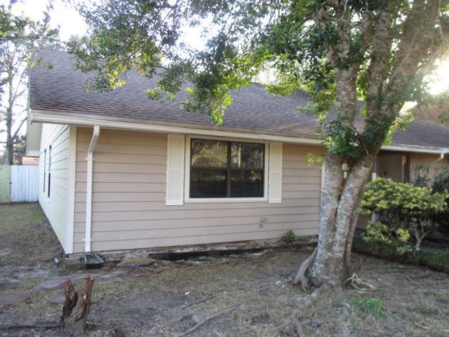 This 3 bedroom 2 bath unit boasts an open floor plan with a large kitchen, ample living room and dining room space. Wood floors in all living areas except for the tile in the kitchen and baths. The kitchen has new counter tops and new stainless steel dishwasher and stove. New vanity top and sink in the hall bath. Interior laundry room off the hall bath. There is a large fenced back yard for your privacy and entertaining. The driveway is wide enough for 2 cars to park side by side and ample parking available across the street. Call to make an appointment to view today