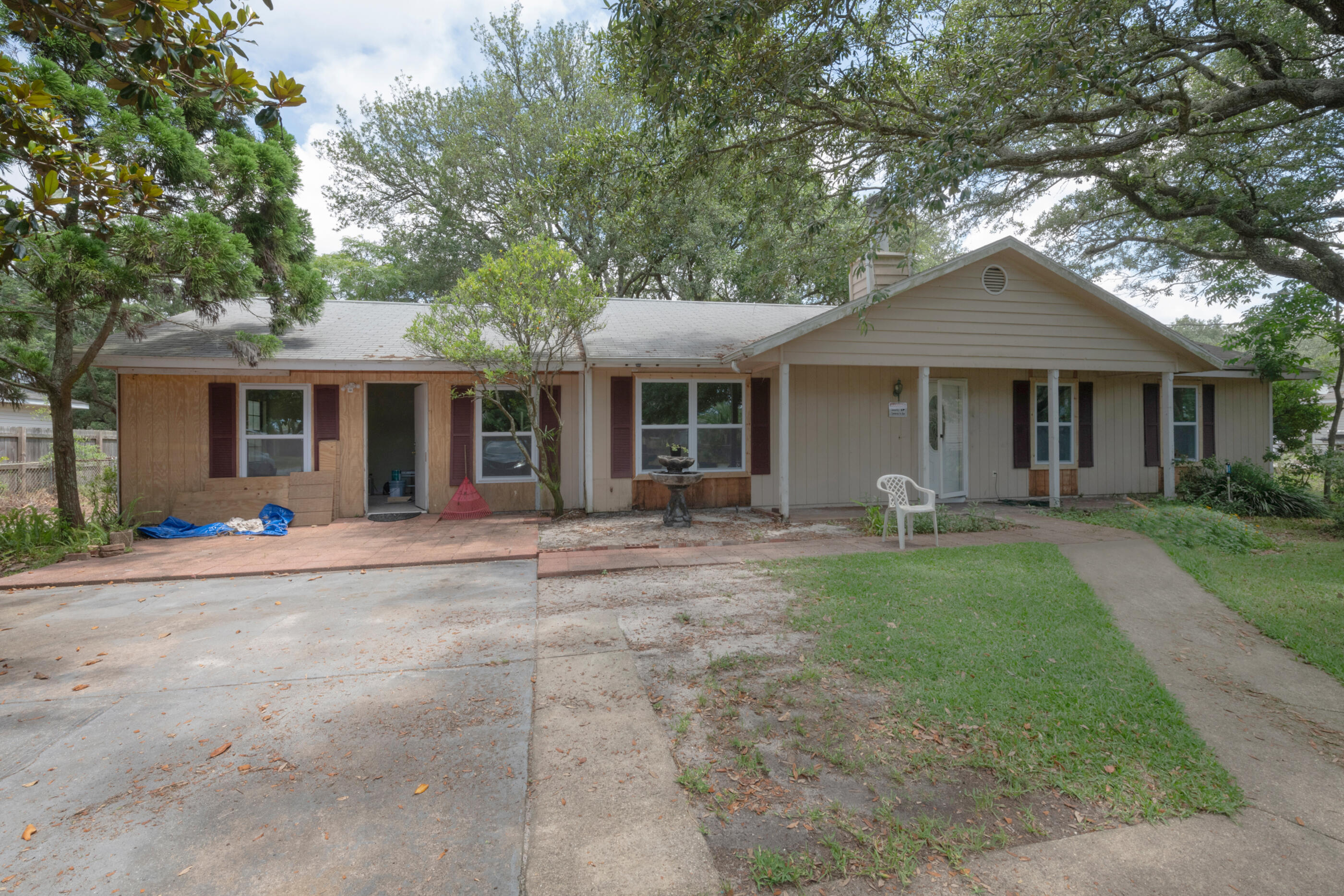 BACK ON MARKET WITH PRICE REDUCTION! INVESTMENT PROPERTY OR PERSONAL RESIDENCE! TWO AREAS FOR INCOME ON THIS HUGE LOT IN A GREAT LOCATION WITH PARKING FOR EACH! This 3 bedroom home with 2 full baths and a large Florida room has an attached in law suite with 1 bedroom, 1 bath, dining and kitchen area with front and back access and it's own driveway! Can use access into house if choose to do so as well! Rent each out or live in one part and rent out the other! House needs finishing touches. Walking distance to stores, restaurants, pharmacy and the sound. Public boat ramp across the street and a few minutes drive to the beach. This is a must see home in a great location! Measurements are approximate. Buyer to verify. Current survey.
