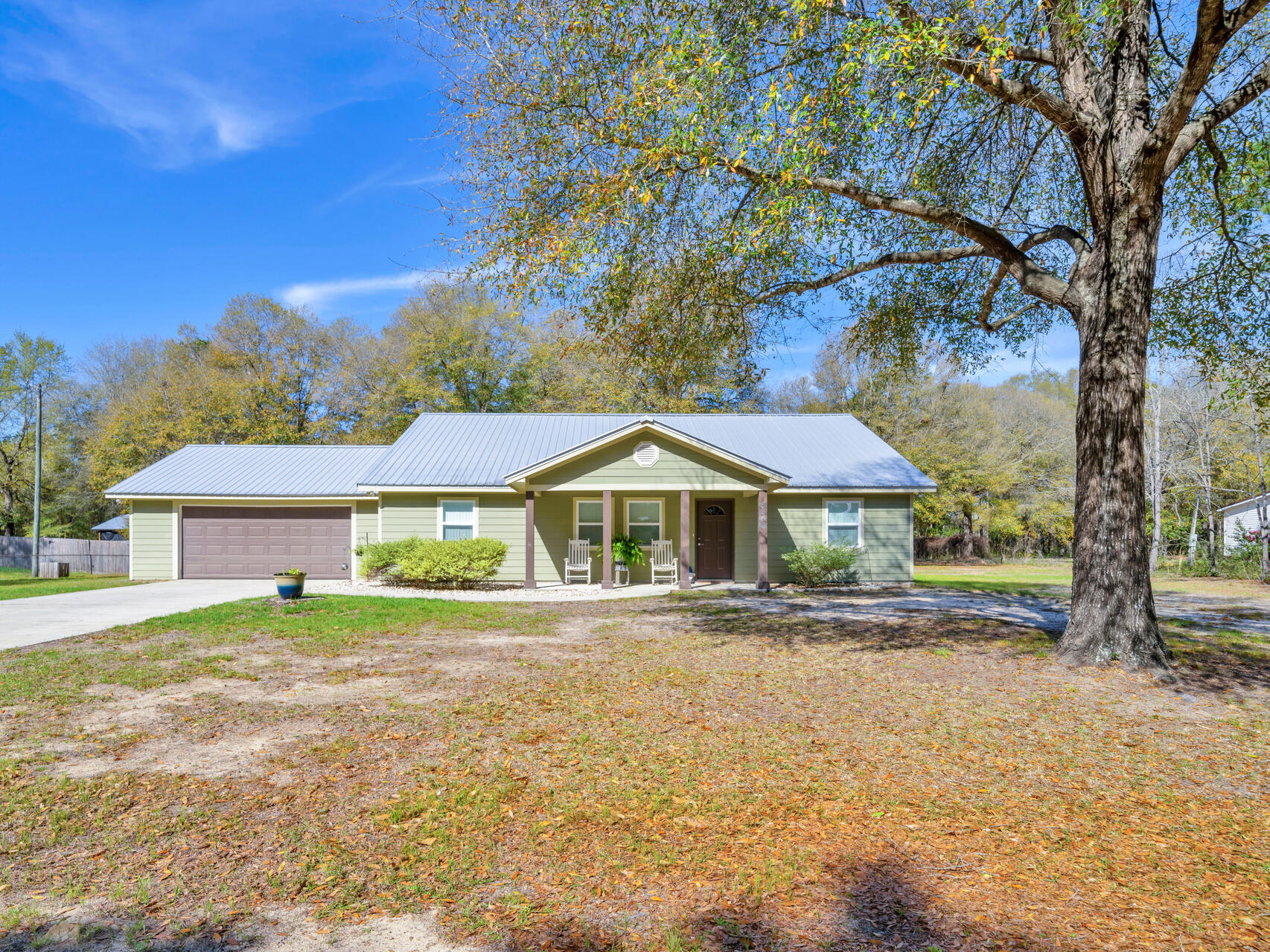 Sitting on 1 acre, this 2017 custom-built home offers fantastic outdoor living with a 500+ sq. ft. covered porch, paver patio with pergola, and a professionally installed pole barn on a concrete slab for RV/boat storage. Inside, the master suite features a walk-in closet and a dedicated vanity space, with custom-tiled showers in both bathrooms. The kitchen boasts a 6-foot island with ample storage, and flooring is tile throughout with carpet in bedrooms. Additional features include a tankless water heater, manifold system, partially floored attic, Hardie Board siding with joint flashing, termite bond, and no HOA. Meticulously maintained--don't miss this one! *outside fridge does not convey.
5346 Fox Hound Ln, Baker Fl 32531
Located just minutes from town, this custom-built 2017 home sits on one acre and has been meticulously maintained by its original owner. Designed for both comfort and functionality, this home offers thoughtful details throughout. Step inside to find an accessible master suite featuring a walk-in closet and a designated vanity space in the bathroom. The custom-tiled showers in both the master and hall bathrooms add a touch of elegance. The open kitchen boasts a 6-foot island with ample cabinets and drawers, providing plenty of storage and workspace. Flooring includes tile throughout, with carpet in the bedrooms for added warmth. The home is equipped with a tankless hot water heater, a manifold water system, and a partially floored attic for extra storage. The exterior is just as impressive. The garage's back door opens to a paver patio and pergola for backyard grilling, while the back door leads to over 500 square feet of covered porch with three ceiling fans, perfect for outdoor relaxation. A 35 foot pole barn on a concrete slab provides additional storage options. The Hardie Board siding with joint flashing ensures durability, and a termite bond adds peace of mind. For those who love a touch of nature, grape vines enhance the outdoor space. With no HOA, this property offers flexibility and privacy. Don't miss the chance to own this well cared for home with unique custom features. Schedule your showing today!