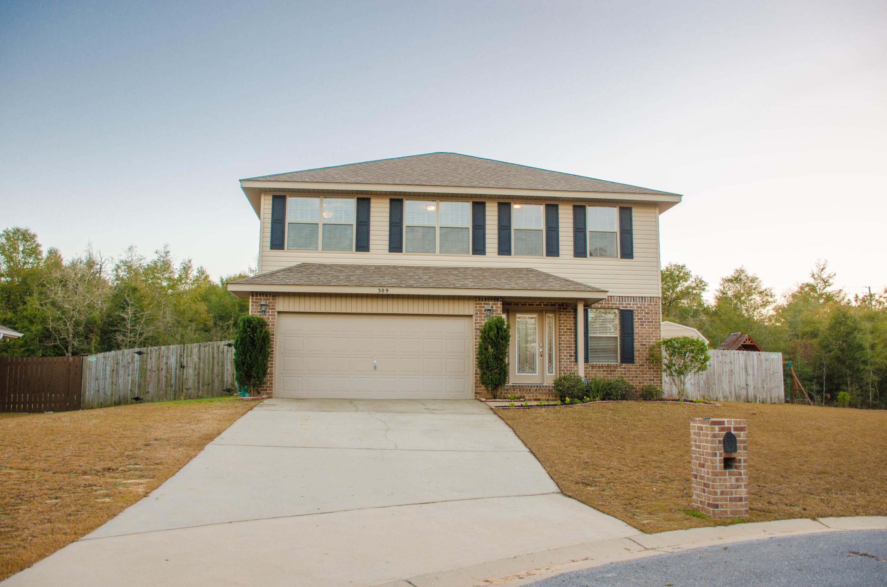A beautiful glass leaded front door greets you as you walk up to this impressive home. As you enter your eyes will focus on the soaring ceilings and spacious family room. Beautiful NEW LAMINATE WOOD FLOORING flows from the family room ,dining room and into the kitchen.Interior has been completely painted. The well appointed kitchen includes STAINLESS STEEL appliances, dark wood cabinets, breakfast bar . A great feature of the home is a bedroom/office with bathroom on the first floor. Three additional bedrooms are on the second floor, including the master complete with a trey ceiling. Master bathroom has a double vanity, garden tub, separate shower and a large walk-in closet..Two additional bedrooms share a hall bathroom. Fenced in level back yard complete with a shed and patio.
