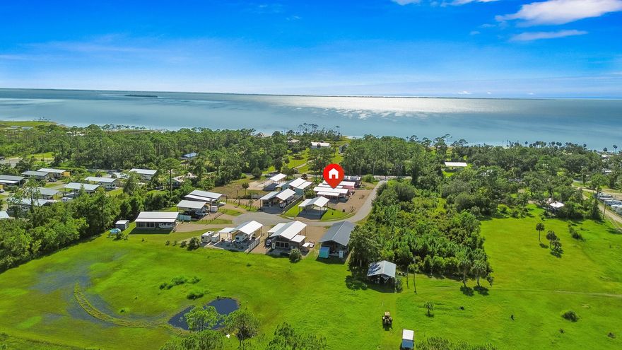 Investment property or personal getaway--this improved RV lot offers both! One of only 11 lots in ''Bayou Club'' RV Community in Simmons Bayou. No HOA and strong rental potential with area rec lots averaging $1,500/month. Across from St. Joseph Bay, approx. 7 miles to Cape San Blas, 5 miles to Port St. Joe, and under 25 miles to Apalachicola. Features include full hookups (water, sewer, electric), RV pad, gravel lot, 60x30 pole barn, 48x16 wing shed, dusk-to-dawn lighting, outdoor dining area, screened porch, storage room, and flex space. Conveying items include patio furniture, grill, and accessories. Low-maintenance, high-value coastal retreat.