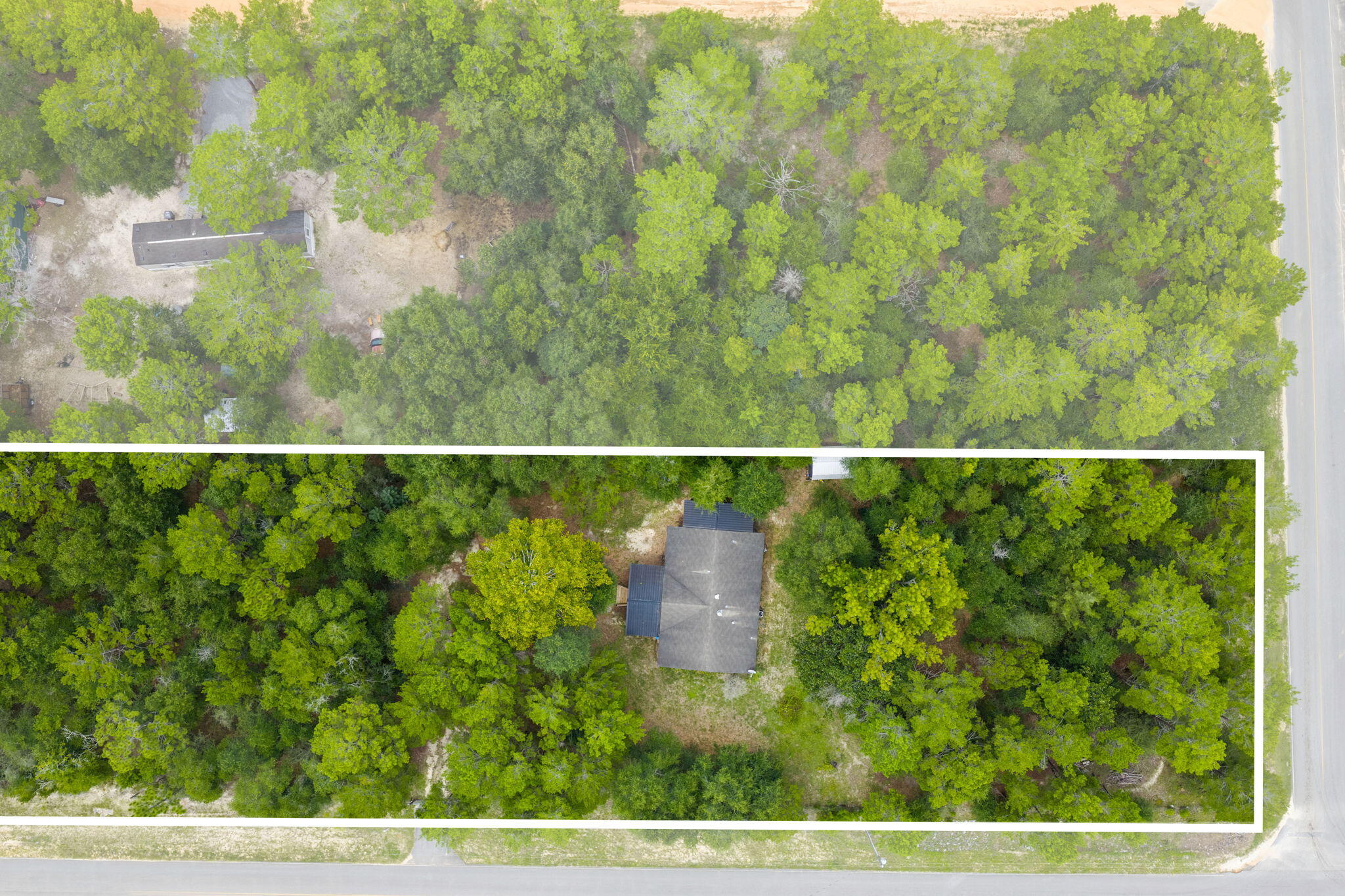Spacious Property on 6 Lots totaling 1.376 Acres! This 2013 three-bedroom, two-bath mobile home is fully fenced with an automatic gate for privacy and security. A 20' x 12' custom-built front porch, added in 2014, offers storage underneath, while a 19' x 6' side porch built in 2017 features easy access stairs and additional storage--both perfect for relaxing and enjoying the peaceful sounds of nature all around you. Inside, the kitchen is filled with natural light, highlighted by matching appliances and a convenient pantry. A private laundry room includes a washer and dryer for added convenience. The primary suite offers a standing shower and a spacious garden tub for relaxing at the end of the day. Outside is a shed that provides plenty of space for lawn equipment or extra storage. With the flexibility to keep the property as a whole or separate the six lots for individual sale, this home offers both comfort and investment potential. Buyer should do due diligence in verifying all dimensions and anything else of importance.