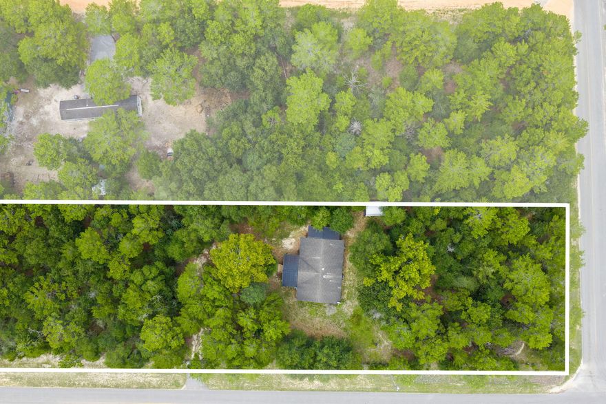 Spacious Property on 6 Lots totaling 1.376 Acres! This 2013 three-bedroom, two-bath mobile home is fully fenced with an automatic gate for privacy and security. A 20' x 12' custom-built front porch, added in 2014, offers storage underneath, while a 19' x 6' side porch built in 2017 features easy access stairs and additional storage--both perfect for relaxing and enjoying the peaceful sounds of nature all around you. Inside, the kitchen is filled with natural light, highlighted by matching appliances and a convenient pantry. A private laundry room includes a washer and dryer for added convenience. The primary suite offers a standing shower and a spacious garden tub for relaxing at the end of the day. Outside is a shed that provides plenty of space for lawn equipment or extra storage. With the flexibility to keep the property as a whole or separate the six lots for individual sale, this home offers both comfort and investment potential.  Buyer should do due diligence in verifying all dimensions and anything else of importance.