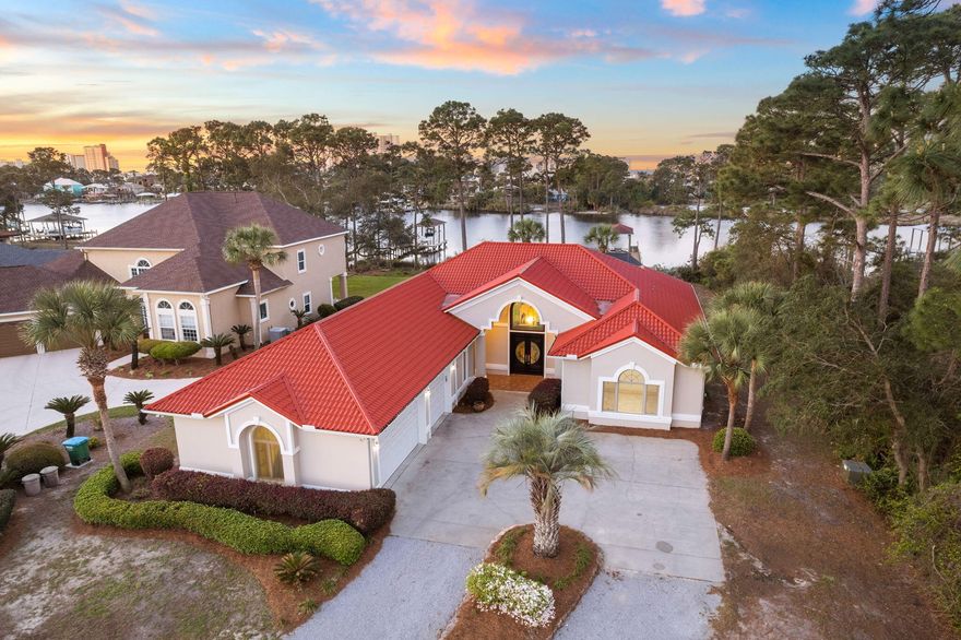 Perfectly positioned on highly sought after North Lagoon, relaxed waterfront living and privacy meet at this impressive estate on nearly an acre. Deep water access and just minutes from the open Bay, you'll enjoy a waterfront home that will stand the test of time. Built of Insulating Concrete Forms (ICF) construction and a roof made of steel, this home is a fortress, said to withstand winds at 200 mph+. Boasting over 100' over waterfrontage, a boat dock, boathouse and boat lift, this home is calling all boat/fishing enthusiasts! North Lagoon is known for its incredible sunsets that can be enjoyed from your private screened-in pool or the expansive backyard.