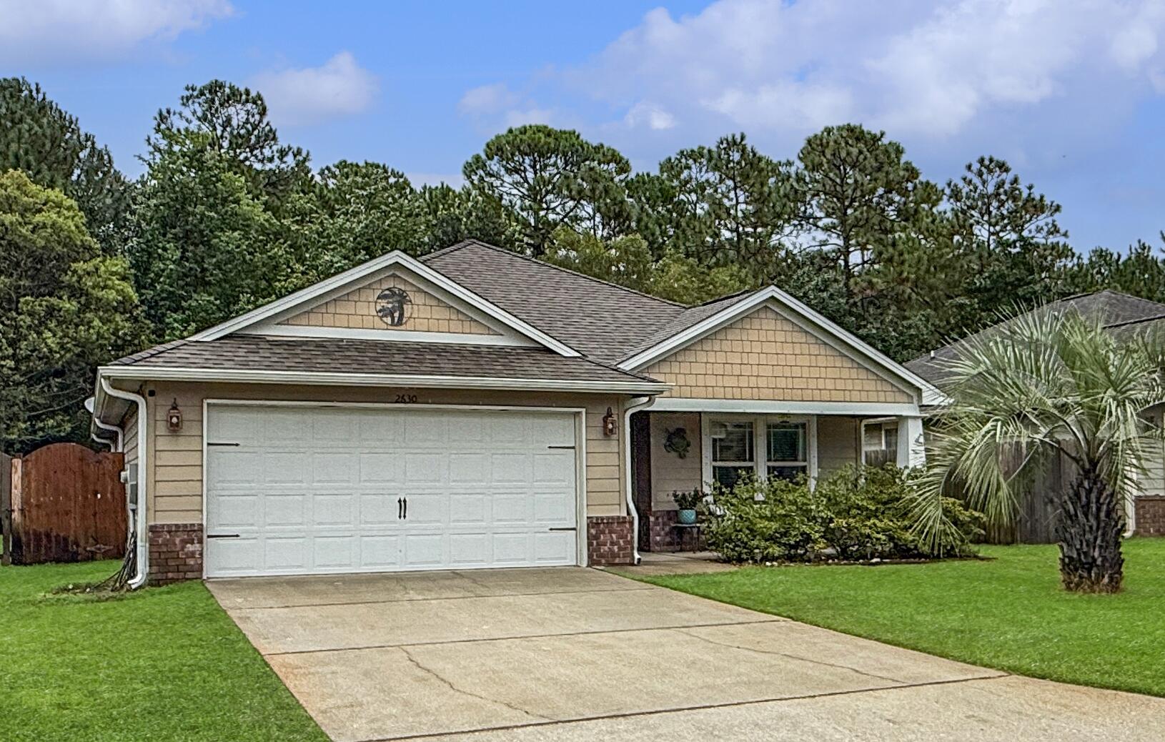 Welcome to this beautifully maintained home in the sought-after Cottages at East River. Tucked away on a quiet street with no cut-through traffic, this craftsman-style home offers both privacy and convenience--just minutes from Navarre Beach, Hurlburt Field, and local shopping. Inside, an open layout is enhanced by tile flooring throughout, providing durability and easy upkeep. The vaulted ceilings in the living area enhance the bright, open, and spacious feel of this home. The bedrooms are generously sized, while the guest bath is oversized for added comfort. The kitchen serves as an inviting hub, featuring granite countertops, stainless steel appliances, and a breakfast bar perfect for everyday living. Step outside to a covered patio and fenced backyard overlooking a wooded conservation area, where local wildlife can often be spotted. This outdoor space is ideal for relaxing, grilling, or enjoying the natural surroundings. With hardy board siding, hurricane protection, and a sprinkler system, this home also offers low-maintenance peace of mind. Combining comfort, style, and functionality, this Navarre home is ready to welcome its next chapter.