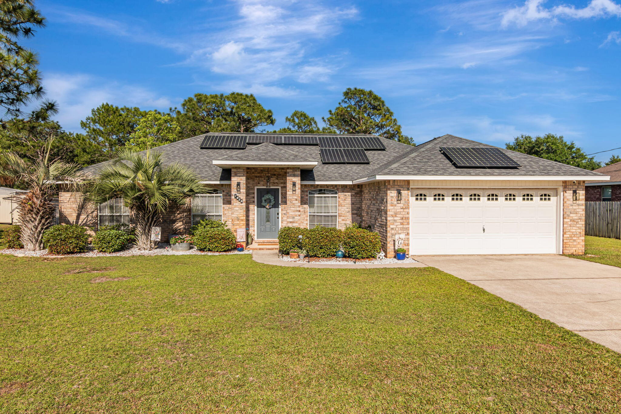 **SOLAR PANELS ARE PAID OFF** and currently has an energy credit with electric company! 4.75% VA assumable loan. Immaculately kept, all-brick ranch in a very desirable community. This home features everything you want such as dining room, eat-in kitchen, designated office space (currently being utilized as a gaming room,) a split floorplan to offer privacy, cozy living room with wood burning fireplace & an expansive .46 ac lot with sprinkler system. Most of the home features LVP flooring & tile with 1 bedroom having carpet. W/D convey. Included in Holley By The Sea HOA is membership to the waterfront rec center with 3 swimming pools, 8 tennis courts, exercise/workout room, private beach, fishing pier and more! HVAC (with ionizer to aid with allergies) 2021 Water Heater 2017 Roof 2022.