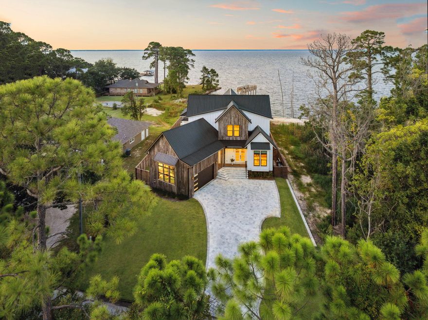 Welcome to this stunning new construction bay-front home in Miramar Beach, offering 3,035 square feet of well-designed living space. This property features four bedrooms and five bathrooms, along with a dedicated office and versatile loft, providing plenty of room for both comfort and functionality.The home boasts over 550 feet of covered porch, perfect for enjoying the beautiful bay views. A detached carriage house offers additional space for guests. For water enthusiasts, the private dock comes with a boat slip, making bay access easy and convenient.Enjoy the luxury of a heated and cooled pool and spa, ideal for relaxation and entertainment. The second-story viewing deck provides a perfect vantage point for taking in stunning sunsets or hosting gatherings.