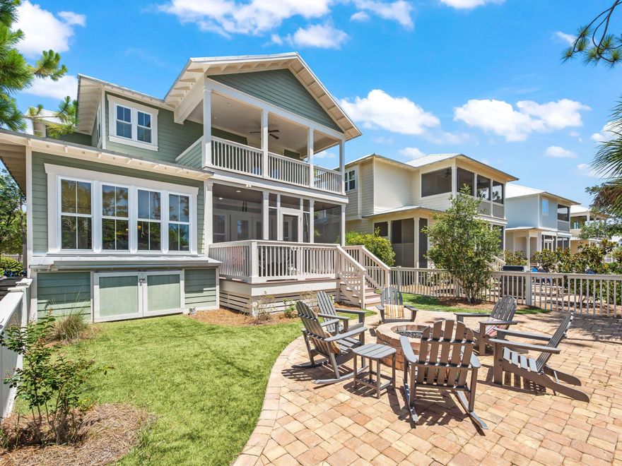 Crafted to the highest specifications, this classic home has an attractive facade with upper and lower porches and interesting architectural trim. Climb the porch steps to the shaded area that provides a welcome place to retreat with iced tea and watch the world go by. Completed in 2014, the sizable home has many bespoke features. The two-story foyer has doors to the guest suite and full bath before opening into a spacious open family room with hardwood floors. The living area has ample space for socializing and relaxing beneath the dark beamed ceiling with an imposing fireplace flanked by craftsman-built cabinetry. The kitchen is a chef's dream with a huge granite-topped island and integrated double sink. It provides ample space for cooking, dining and serving drinks and nibbles when entertaining. Pull up a stool for breakfast and engage with the cook. A separate dining nook provides a gracious area for formal dining with serene views. Upstairs has many more desirable features including two sets of built-in bunks with an adjoining sitting area. Highlights of the elegant master suite include access to the huge second-floor porch for morning coffee overlooking the surrounding landscape. The luxurious marble ensuite boasts a corner tub and separate walk-in shower. Outdoor entertaining space was added to the backyard oasis, backing onto a nature preserve, where room remains to add a pool. The elevated deck is perfect for sunset views and barbecues while the pavered terrace is designed for stargazing and toasting marshmallows around the fire pit after dark. This exceptional home is enviably situated for enjoying all the amenities at NatureWalk at Seagrove. Close by is a nature pond and a beach-entry community pool at The Gathering Place. There's an additional heated lap pool, playground, sports courts and kiddie pool along with miles of traffic-free trails with fitness stations. Take a quick bike ride to the beautiful beach, just one mile away, and look forward to frequenting beachside cafes, shops and restaurants in this high-end area of East 30A.