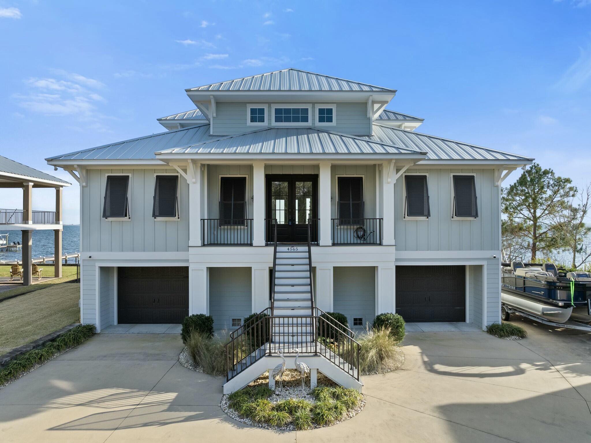 Welcome to coastal luxury with this custom-built 2019 waterfront home, perfectly positioned off of scenic Soundside Drive. Designed with elegance, durability, and functionality in mind, this meticulously crafted residence offers breathtaking sunset views, premium features, and direct water access. Inside, you'll find a custom gas fireplace surrounded by built-in bookshelves, adding warmth and character to the main living space. Beautiful hardwood floors on the first floor lead you to the fully appointed gourmet kitchen complete with a custom pantry, offering fantastic storage and space for those who love to cook. The office with large windows overlooking the Santa Rosa Sound provides a serene and inspiring workspace. A geothermal heating and cooling system ensures year-round comfort, with separate climate control for upstairs and downstairs. Two tankless water heaters provide an uninterrupted hot water supply, while a 950 lb capacity interior elevator offers effortless access between floors. Upstairs, a custom bunk area provides extra sleeping space and could easily be converted into a fourth bedroom, complementing the two additional bedrooms and baths. The master suite features a large walkthrough closet leading directly to a well-appointed laundry room. Outdoor living is at its finest with expansive first- and second-floor decks, complete with a natural gas grill and outdoor cooking area with granite countertops, perfect for entertaining or just relaxing and taking in the water views. Equipped with a wired speaker system, this home is designed for both relaxation and entertainment. The gated and fenced backyard offers privacy and security, making it ideal for pets or simply enjoying a peaceful retreat. After a day on the water, unwind in the heated plunge pool, or take advantage of your own private pier with boat and jet ski lifts, complete with a lower platform ideal for fishing or just sitting and watching the boats pass by. Make your appointment today!