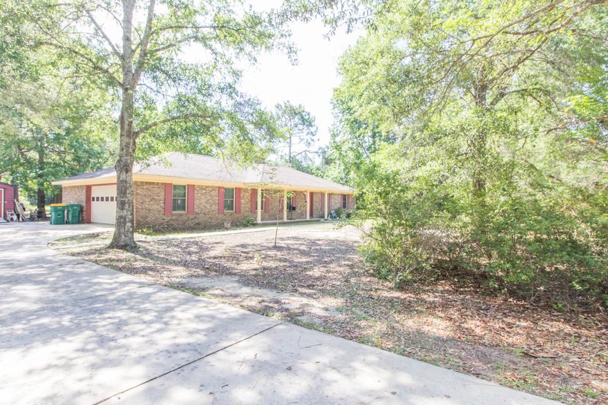 Looking for a large yard but don't want to sacrifice the commute to work? Well this 3/2.5 bath home is waiting for you. Home sits on .83 of an acre, has a screened area for cookouts and entertainment as well a screened in and glass enclosed sun-room with a window unit. Large formal living as well separate den ( living room area) for plenty of space to entertain. Kitchen has lots of cabinets and counter space for all your cooking needs. Home has tile and carpet, brick fire place, laminate counter tops, HVAC replaced 2011, Roof in 2009, and Windows in 2011. There is a 1/2 bath (mud room) in the garage.The large yard allows for plenty of space for the kids and family dog to run around and enjoy. Schedule your showing today.Sellers transitioning out,please pardon their progress