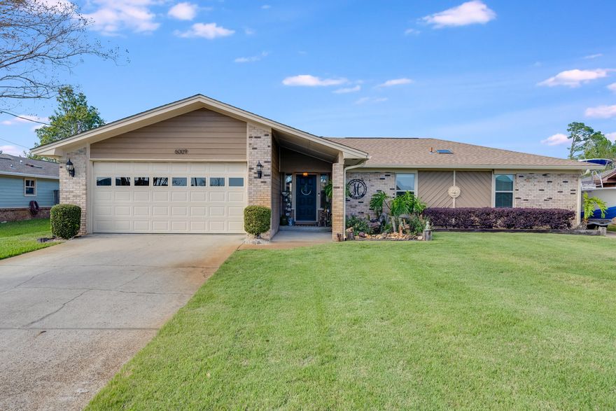 Welcome to 6009 Stephanie Drive, an exquisitely renovated and maintained home with a lush landscaped backyard and incredible outdoor screened flex room. This beautiful home offers 3 bedrooms, 2 bathrooms and a 2-car garage all on a large .27 acre homesite. If you are looking for a home with top-notch curb appeal then you have found the one! Upon walking up to the front door you will see a magnificent custom-made koi fish pond and true oasis with landscaping that begins right as you walk up to the home. As you walk through the front door into the foyer that has beautiful herringbone pattern on the entryway. flooring. Looking through you will see a large, open living room with a beautiful vaulted ceiling and brick fireplace. The perfect spot to spend time with family and not feel confined. Offering durable LVP throughout, the open concept features a beautifully-crafted open kitchen/dining area which features a large island with an abundant amount of countertop area and plenty of cabinets for storage. Around the corner is the large laundry room/pantry. The laundry and pantry room also give access to the large 2-car garage. Across the house you will find the 3 bedrooms and 2 bathrooms. Both of the guest bedrooms are a great amount of square footage with plenty of closet space. The hall bathroom was fully renovated and features a tiled bath/shower combo. The master suite offers great natural light with two closets and a luxurious en suite bath. One side has a large walk-in closet and the additional closet is great for two! The primary suite's bathroom offers a beautiful tiled shower and neutural vanity. Step into the back yard of the home is a huge back porch with a built in gazebo and a screened in polebarn. This pole barn has electrical ran to it and is the perfect place to entertain friends and family. This will keep you safe from insects and allow you to see the majestic Florida sunsets every evening. Along with that the back yard has extremely mature and well maintained landscaping throughout, the current owners have spared no expense when it comes to the front and back yards. This is truly a wonderful home that is ready for the right family to love. Make sure you see this remarkable home before it's gone.