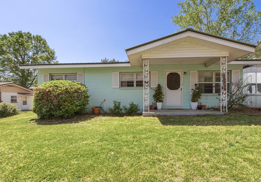 If a small, hometown vibe is on your checklist for your next home, then welcome to Florala, AL. This delightful 3-bedroom, 1-bathroom home was built tough with cinder block construction and a metal roof. The inviting front porch is perfect for quiet mornings with coffee before stepping inside to find generous sized living room leading to a spacious kitchen with plenty of cabinets and storage. The enclosed back room serves as laundry room but is large enough for hobbies and even includes an additional 8x9 storage room. Outside you will find a 2-car carport, storage building and expansive yard await gardeners and entertainers alike. Within close proximity to downtown activities, this location is one to check out. Schedule your showing today!
