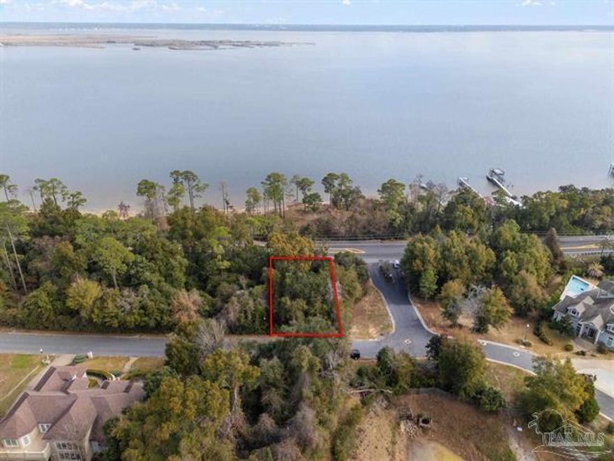 Build Your Dream Home with Stunning Escambia Bay Views!Discover the perfect canvas for your dream home in the prestigious Macky Bluffs community, an upscale custom home subdivision in highly sought-after Northeast Pensacola. This exceptional 0.35-acre wooded corner lot offers breathtaking views of Escambia Bay and a gentle slope from front to rear, allowing for a home design that includes a garage or basement area beneath the living space.Key features include:Completed soil studies and survey - ready for construction.House plans available - take advantage of a head start. No flood insurance required (Zone X) - enjoy the beauty without the extra cost.Nestled off Scenic Highway with two convenient entrances, you'll have quick access to I-10, top-rated hospitals, shopping.