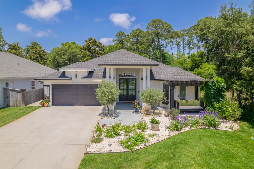 Welcome to this stunning custom-built home, where every detail has been carefully crafted and impeccably maintained. With over 2,500 sq ft of living space, this 4-bedroom, 3-bath beauty features a newly installed screen enclosed pool and serene views of the sound right from the front door. Step into a welcoming foyer with soaring ceilings that set the tone for the elegance throughout. Wood-look tile flooring flows seamlessly throughout the home. Off the foyer, two spacious bedrooms and a full bath offer comfort and privacy--one with direct access to a patio and covered pergola, positioned perfectly for views of the sound. The open-concept kitchen, living, and dining area is both grand and cozy, featuring cathedral ceilings and custom built-ins. The kitchen boasts elegant finishes with cu stom cabinetry, quartz countertops, a large island, stainless steel smart appliances, as well as a walk-in pantry. The primary suite is privately situated and generously sized, with two walk-in closets equipped with wood shelving, dual vanities, a freestanding tub, and a gorgeous tiled walk-in shower. The fourth bedroom and third full bath situated in its own hallway offer even more flexibility. Step outside to your own backyard sanctuarydouble doors lead to a large screened in veranda with a stained wood ceiling. The veranda flows perfectly outside to a gunite saltwater pool and spa, fully enclosed for year-round enjoyment. Beyond the pool lies a beautifully landscaped yard with a garden bed and a grassy area. Additional features include wi-fi boosters throughout the home, hardwired camera system, 7-stage water osmosis filter, spacious laundry room with a sink and cabinetry for storage, and a 2-car garage. Located near Woodlawn Beach boat ramp and with no HOA, there's room to park your boat or RV right at home. This rare gem offers the perfect blend of luxury, comfort, and coastal charm.