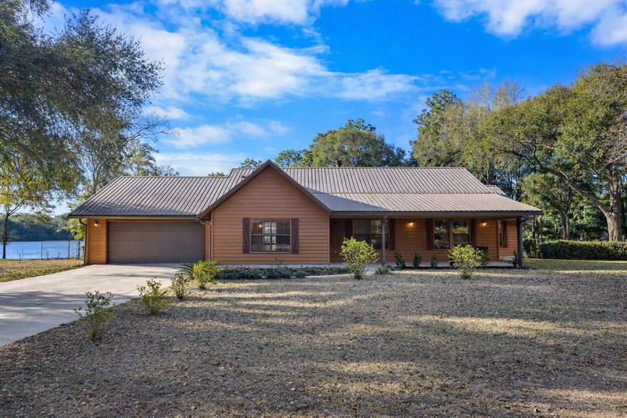 This is a first-time offering for this waterfront property priced to sell. The home is five minutes from downtown Crestview, located at 3066 Craig Terrace, a beautiful, quiet, well-appointed tree-lined street. This beautiful home is situated quietly on one of Crestview's largest lakes, spanning nearly 42 acres. Keep your John boat on your dock and go fish because this beautiful lake has Florida largemouth bass, blue channel catfish, bream, and crappie. You will enjoy watching the sunsets over the lake on the screened-in back porch. The property spans 1.66 acres with fruit trees, a large yard, and a custom shed measuring 12x32x12 with overhead loft storage. This home is a sprawling 2,130 square foot one-level ranch 3 bedroom 2 bath with a living room for a Home Office. The home boasts an oversized 2.5-car garage and a large driveway for six vehicles.  If you're looking for serenity, your search is over.
