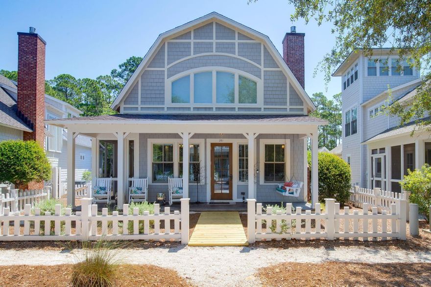 Tucked beneath a charming Dutch-barn-style roofline, this quintessential beach cottage is set behind a white picket fence. It's superbly located for enjoying the nearby beach and plentiful WaterSound amenities. Recently refreshed with new flooring, new paint, HVAC, hot water heater, and furniture, this delightful home is the perfect beach retreat. The open-concept living/dining area is light and bright with a profusion of windows and a cozy fireplace feature. Full-height cupboards in the well-appointed kitchen offer plenty of storage along with a range of stainless appliances. It's the natural hub of the home, designed for easily serving up everything from breakfast pancakes to pre-dinner cocktails at the stylish breakfast bar. Two bedrooms on the first floor offer stair-free access and