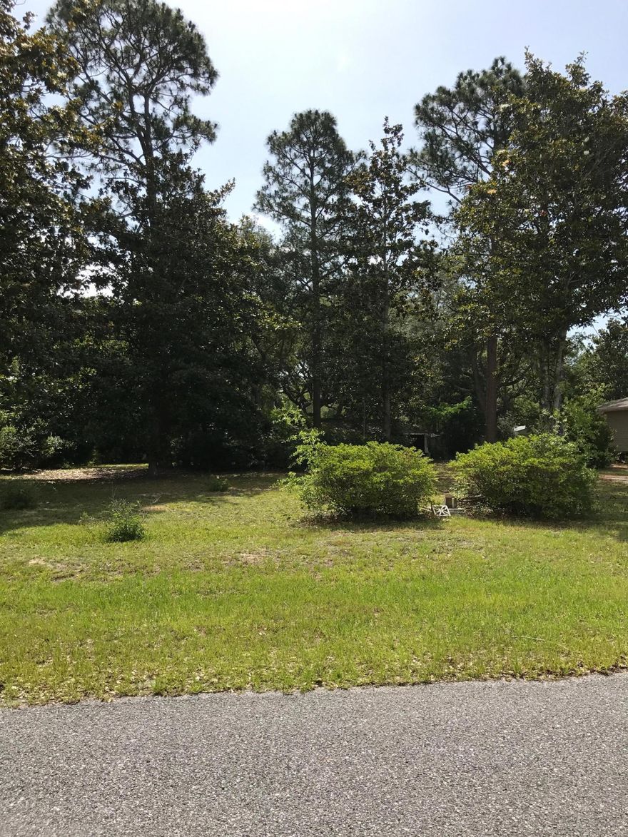 Lot semi cleared with mobile home, no value