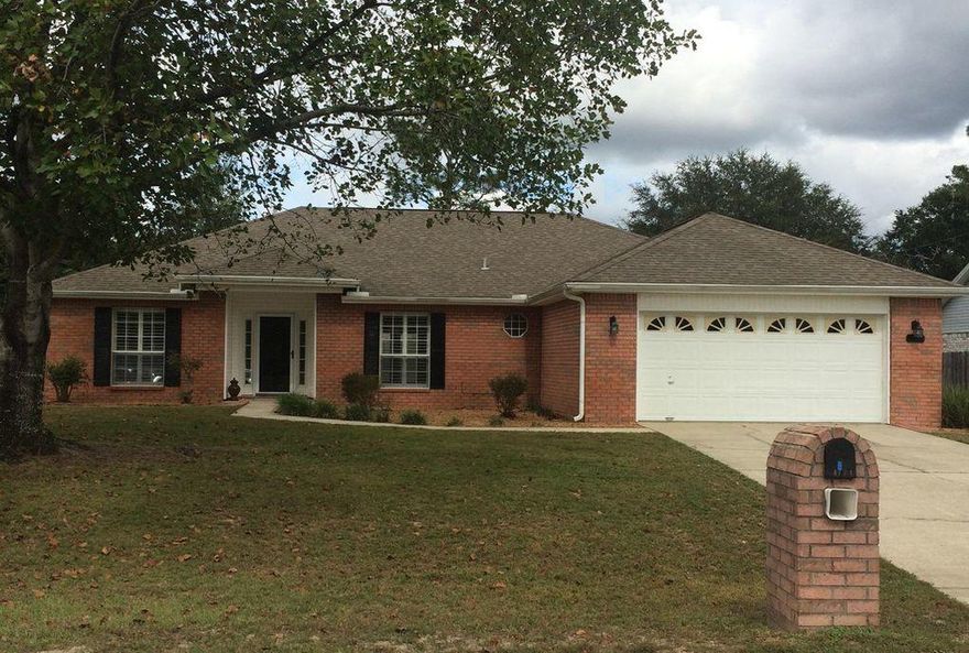 SOUTH OF I-10!! CLOSE TO DUKE, SFC, EGLIN AFB. Better than new, has everything you would add to a new home: privacy fenced yard, large back yard, $4000.00 worth of plantation shutters. Many new items: beautiful laminate flooring, carpeting in all bedrooms, garage door opener, heat pump, DR chandelier, water heater and lawn pump. Vaulted ceiling and triple arches create attractive dining room along with cathedral ceiling, plant ledges and fireplace in LR. Remote controlled ceiling fans in kitchen and great room. Cathedral ceiling in large kitchen, complete with island breakfast bar and pantry, breakfast nook with bay window. The master bedroom suite has a huge walk-in closet and separate linen closet. .