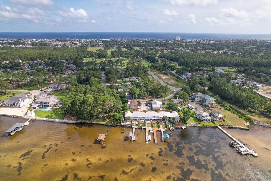 BAYFRONT TOWNHOME! NO HOA!!  END UNIT!! Rental Projections up to $45,000.  This unit is very unique with its own fenced in backyard which is great for privacy and is located directly off of the Bay.  This townhome boast beautiful views of the water for a morning cup of coffee, quiet morning yoga session, as well as so much more. This bayfront property offers the perfect access for your boat, kayak, or paddleboard for year-round enjoyment.  It also includes an enclosed Florida room which adds to the square footage shown. Unit 10 is just a short drive to our amazing white sandy beaches, Silver Sands Outlet Mall, Destin Commons, and an endless amount of restaurants. Washer and Dryer included.  Dock needs to be replaced, and there is a quote provided by Agent. Buyer to verify all dimensions.