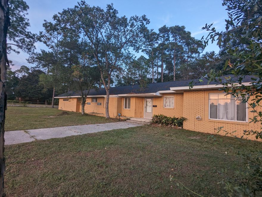 $5K PRICE REDUCTION for a quick sale! Welcome to your fully fenced half acre homestead in central Crestview Florida! This strong custom built gem offers 3 large bedrooms, 1 full bath and a half bath. The hallway and entry lead into the large living room with a fireplace that the owner believes is more esthetic than operational. There is also a large family room off the living room that was a great less formal setting for the family to relax in. The sunroom is located off the living room. There is a large eat-in dining area big enough for a Thanksgiving table. The kitchen received new laminate flooring in 2022, and the oversized 24x27 garage hosts the laundry hookup. The detached garage is a bonus! Call Today!