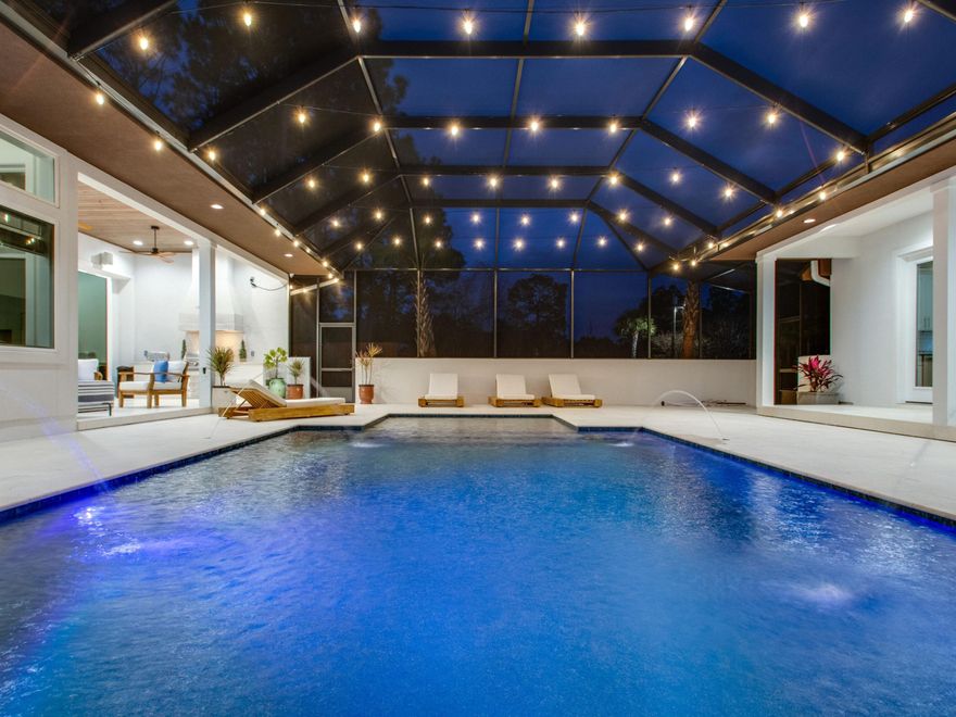 Modern elegance, luxe furnishings and a prime location come together to create the ideal contemporary coastal property in Blue Mountain Beach, complete with an expansive outdoor oasis. Located centrally between two prominent public beach access points, this spacious 3,872-square-foot single-level home was completed in 2020, providing a better than new experience for those desiring new construction without the wait. An articulated three-bedroom and three-and-one-half-bath floor plan is spread consciously throughout the main home, offering ample space for relaxation, family togetherness and fun. The inspiring chef's kitchen is furnished with a ZLine Professional Range, commercial-style oversized fridge, wine cooler and ice maker. Details such as Karndean contemporary LVT flooring and a