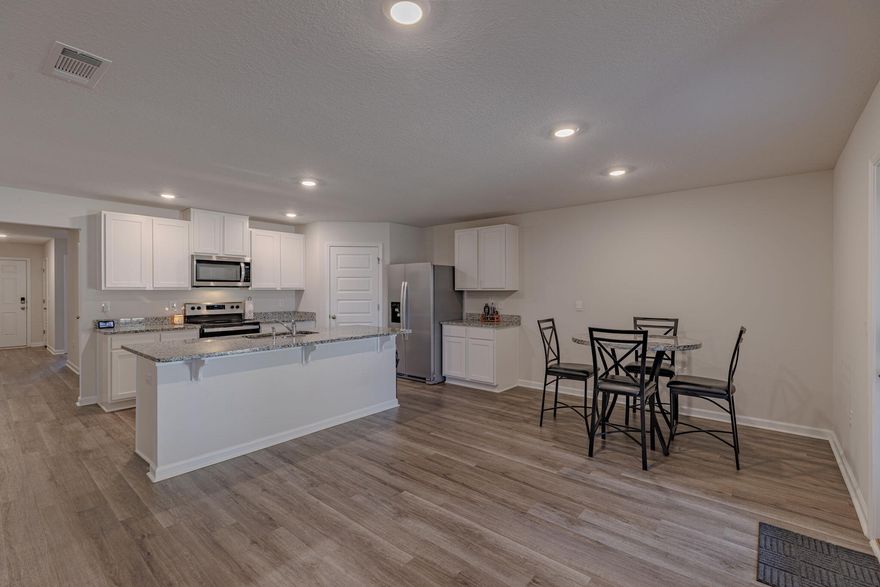 Hot New Price - motivated seller! This stunning 4-bed, 2-bath home features the popular Cali floor plan with 1,830 sq. ft. of well-designed space, backs up to wooded lot for maximum privacy. FHA assumption with rate of 5.99% available to qualified buyer. The open kitchen boasts granite counters, stainless steel appliances, a large island, walk-in pantry, and smart home system. The primary suite offers a walk-in closet, dual granite vanity, large shower, and linen closet. LVP flooring throughout, carpet in bedrooms. Enjoy a covered patio and massive fenced backyard, perfect for a pool, shed, or play area. Solar panels installed to help lower utility costs! Move-in ready--schedule your showing today!