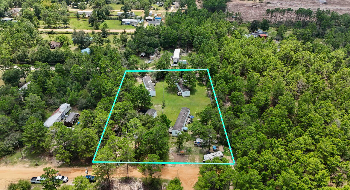 *INVESTOR ALERT!* 4 homes, with equal sized lots, on 1 parcel, all homes got a NEW METAL ROOF & a NEW COVERED PORCH in 2/2025! This nearly 1 acre parcel has 4 manufactured homes (each has it's own mailing address), all of which are 3 bedrooms, 1 bath, 924 sq ft, and built in 2005. Live in 1 and rent the other 3 homes...or rent all 4! (Survey available; rent on all 4 homes totals $3550/month). The first home (142 W Snapdragon St), has a brand new HVAC (5/2025) was recently remodeled and features newer LVP flooring, fresh paint inside and on both outside decks, a new tub! The second home (156 W Snapdragon St), is the last home on a quiet, dead-end street and has been lovingly cared for and kept spotlessly clean by it's 9 year tenant!The third home (143 W Honeysuckle St), was remodeled in 2021 and has 4 year tenants.
The fourth home (155 W Honeysuckle St), has 15 year tenants!
This property is located 10 minutes from I-10, 15 minutes to downtown DeFuniak Springs, and 45 minutes from the pristine white sandy beaches of the Emerald Coast!
Schedule your private showing today! All info in the MLS is intended to be accurate, but cannot be guaranteed. Buyer and buyer's agent to perform due diligence.