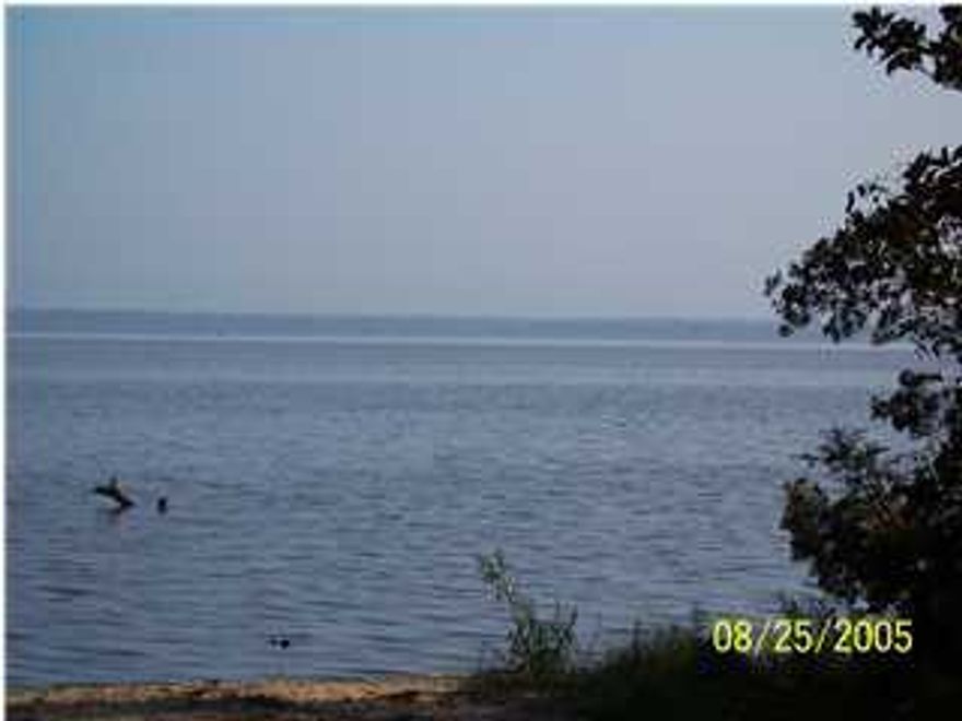 High & Dry wooded residential lot near end of dead-end, low traffic street 2nd row off Bay with possible views.