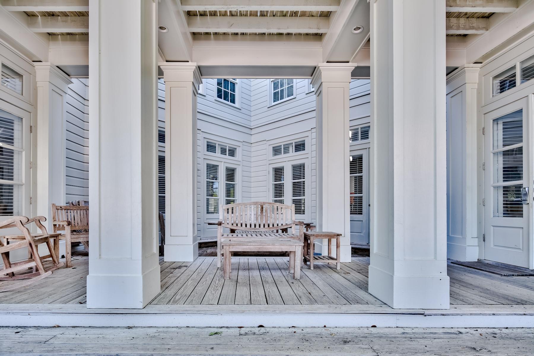 A true historic home designed by Eric Watson and cherished by the original owners is now available. Classic styling in an elegant beach home, Now and Then presently boasts 6 bedrooms, 6 and 1/2 baths and surprisingly expansive spacious living.The first floor opens to a large gathering family room with elegance in detail and natural light found in the finer homes in Seaside. The function of the first floor is completed with a master bedroom and bath, a guest bed with en suite bath, a 1/2 bath for the living area along with the kitchen and the dining area.The second level of the home begins with a living space for the floor surrounded by 4 en suite bedrooms of ample size. Wood trim walls and detail stair railing continue the craftsmanship found in these early Seaside works