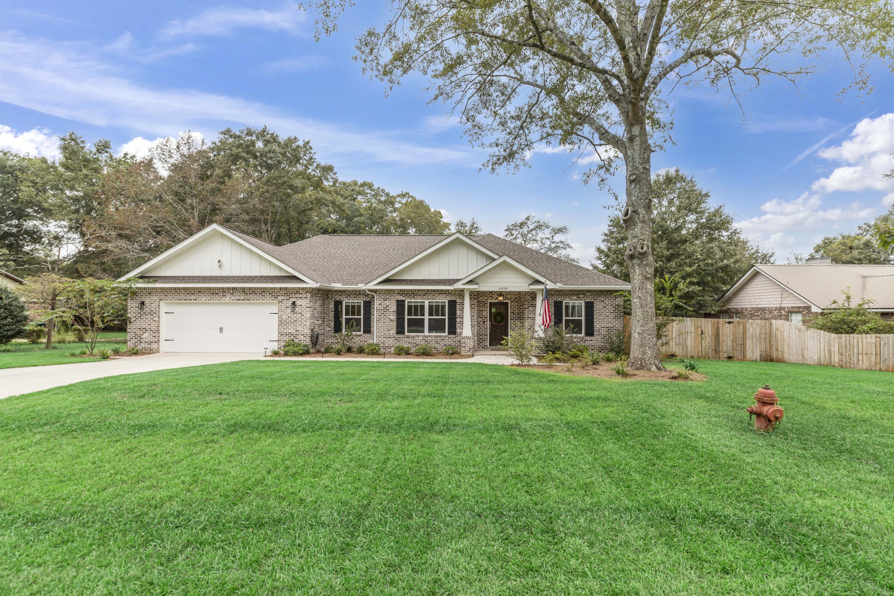 This gorgeous home is located in an established area, just 1 mile from the new Publix shopping plaza and Crestview High School. Better than new, built in 2022, there are so many custom features you are going to love. This home has LVP flooring in living areas, ceramic tile in bathrooms, and carpeted bedrooms. Stainless appliances, quartz countertops, a 7ft flat island, and shaker style cabinetry makes the kitchen a beautiful entertaining space. The dining area is spacious with a built in bench seat. This pantry is a dream with custom shelving and even a window! Nickel finishes on all fixtures. The 'Big Box' builders cant compete with these outstanding features this custom home offers. The custom blinds, stainless refrigerator and privacy fence alone are a huge added value.