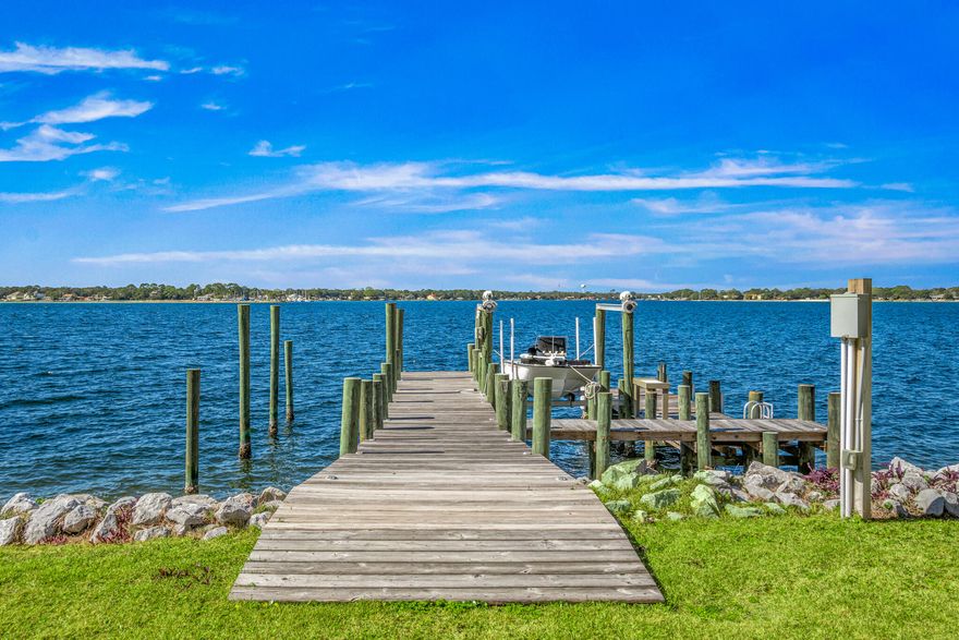 Welcome to The Pointe -- the crown jewel and final available bayfront home in this exclusive 9-lot coastal enclave. Perfectly positioned on a rare point, this custom-designed masterpiece offers uninterrupted panoramic views of the bay, where daily dolphin parades, sailing regattas, and passing fishing boats unfold right before your eyes. From your porch, you'll take in unreal sunsets and soak up cool summer sea breezes in one of the most temperate and peaceful settings on the Gulf Coast.Crafted for effortless indoor-outdoor living, this 4-bedroom, 3.5-bath home features four spacious porches, a cabana room, and a grand open-concept living area with soaring 10' ceilings that frame the water like art.Built to the highest standards with impact-rated glass, soundproof floors, open-cell foam insulation, and an elevator reaching all 3 floors!

Whether you're a boater, angler, or simply someone who craves a front-row seat to nature's daily show, this home is the ultimate expression of bayfront luxury living. 
