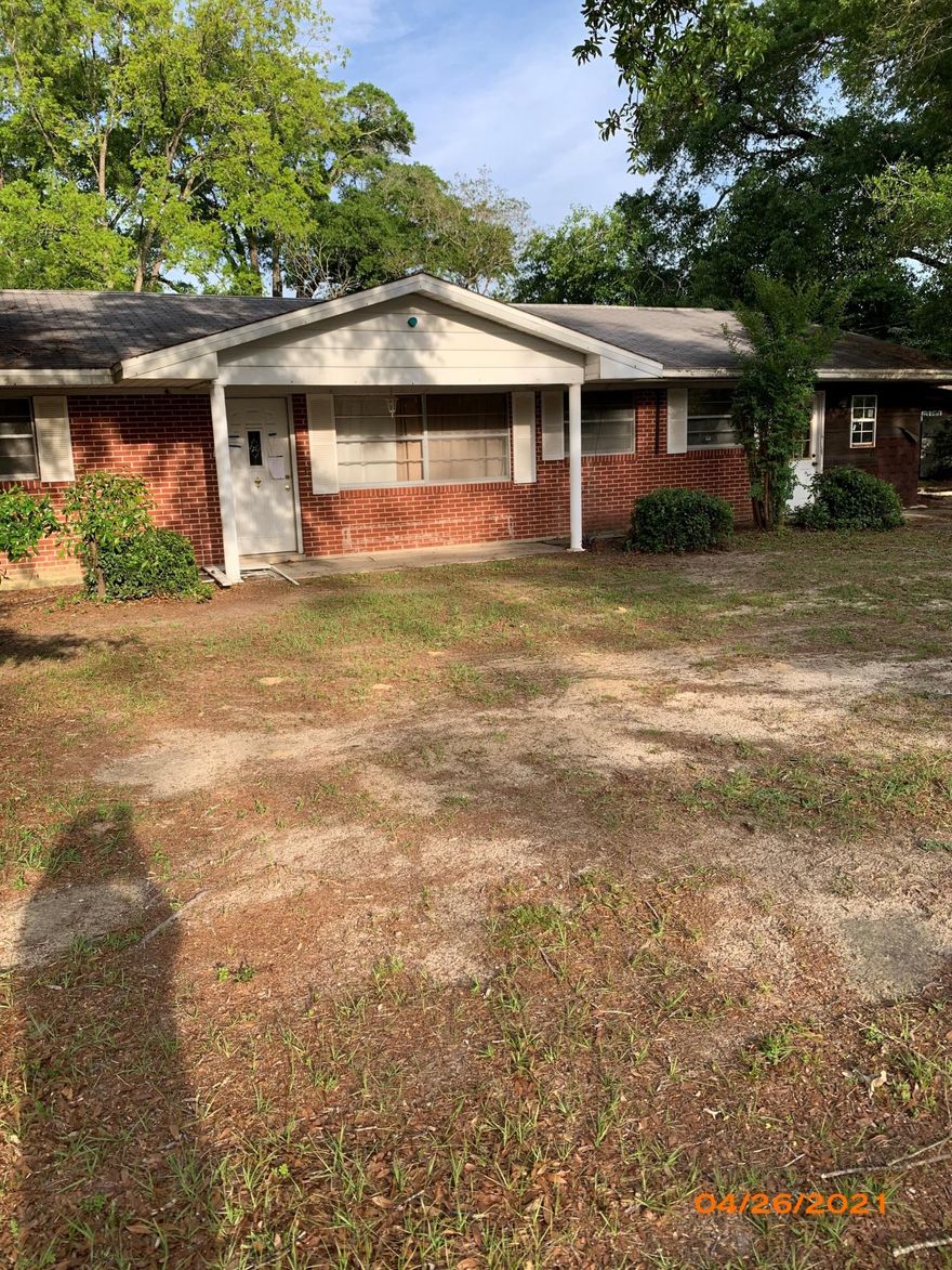 Brick home on large lot near Lake Defuniak. Home has come renovations complete but will not qualify for financing.  Cash only.  Large living room, 4 bedrooms, 2 baths, central heat and air, covered front and back porch.  Master bath is unfinished. Floor covering needed throughout.  Sheetrock work needed. Property being sold AS IS and seller makes no warranties.  Detached 30x20 concrete block workshop. Yard mostly fenced.