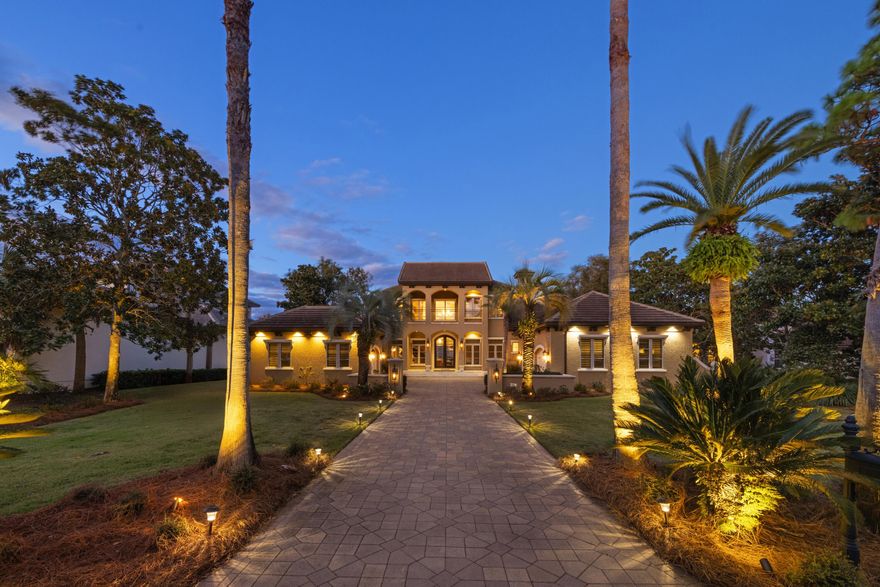 Discover this 4 bedroom / 4 bathroom + office custom-built bayfront home in the gated Regatta Bay Golf & Yacht Club, offering 4,639 sq ft of luxury living with direct access to boating, fishing, and swimming on Choctawhatchee Bay. Enter through 10 ft Spanish cedar double doors into a two-story foyer with a curved wood & iron staircase, barrel ceiling with hand-burnished paint and stenciling, and views of the black onyx saltwater heated pool, spa, lounge area, screened lanai, summer kitchen, and bay dock. The sitting and dining rooms boast a bowed glass window wall, buffet, and cabinetry.  The chef's kitchen includes knotty alder cabinets with lighted antique glass inserts, a hidden pantry with motion lights, granite and wood counters, a large center island, Thermador gas cooktop with griddle, Sub-Zero refrigerator, double convection ovens, wine cooler, Bosch dishwasher, and drawer microwave. Kitchen is open to the living room with gas fireplace, custom stone surround, built-in bookshelves and 24 ft sliding doors blending indoor and outdoor spaces. A downstairs office offers hardwood floors, coffered ceiling, custom cabinetry, water views, and pool access. The primary suite provides a sitting area with double-sided gas fireplace, dual walk-in closets (hers with dresser and granite chest), and a spa bath with walk-in shower featuring dual and rain heads, air-bubbler tub, and dual vanities. Two downstairs guest bedrooms on the opposite side ensure privacy, each with travertine baths including unique sinks, walls, and floors; an upstairs fourth bedroom and bath adjoin the game room with bay views, full bar, dishwasher, beverage cooler, space for pool and gaming tables, and a balcony with porcelain tile and pecky cypress ceiling. Outdoors, enjoy the summer kitchen with gas grill space, stainless steel fridge, cypress cabinets, TV, gas fireplace with Mexican tile, and pecky cypress ceiling, plus a dock with boat slip, lift, and two wave runner lifts. Additional features include a laundry with smart closet, security system, fridge, washer/dryer, sink, and cabinets; three-car garage; whole-house generator; three HVAC systems; two tankless water heaters; plantation shutters; crown molding; 8 ft knotty alder doors; walk-in attic; and exceptional lighting. This manor delivers ultimate privacy, stunning views, and endless entertainment for coastal Destin Florida living. Location is everything when you can take your Golf Cart to Dinner, Shopping, Marina, School and Beaches within just minutes from your home!  Regatta Bay is one of the few resorts with a dedicated red light for easy exit or crossing of Highway 98. Other features are a Golf Academy, covered practice area with greenside bunkers, pool & playground, tennis & pickleball courts, members' lounge, library, locker rooms, pro-shop, Lulu's Restaurant & Bar on the Bay, access to a private pool and bar overlooking Choctawhatchee Bay, boat storage options, a marina ship store, and boating classes.