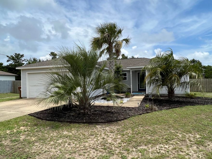 This is one you do not want to miss!  This property is within a short 2 mile drive to Navarre Beach but you would think you were ON the beach when you walk through the front door. Originally built in 1998, this home feel brand new! Tastefully adorned, this 3 bedroom 2 bath split bedroom home has vaulted ceilings, built in cabinets, tiled floors through out and modestly installed lap-siding in the kitchen, bath, and master bedroom. This super cute home rests on nearly 1/2 acres and has tons of room for boat and/or RV parking, space for a pool and comes with a fully furnished Gazebo/entertainment space. Pictures help paint the true story of this awesome home space and make this home a must see. Call today!