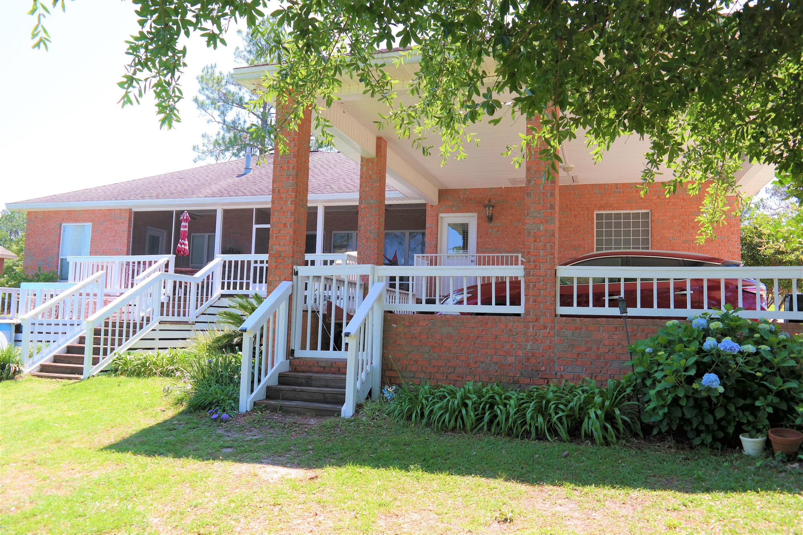 Beautiful custom brick home on the largest lake (apx. 50 ac) in desirable Ten Lake Estates! Oversized 2-car carport can accommodate a small to mid-range RV. Custom granite counter tops and top-of-the-line stainless appliances in kitchen. Master bath has his/hers vanities, jacuzzi tub and large walk-in shower. 8x30 screened lanai opens out to 18x20 open deck overlooking the lake and your own private dock! Beautiful landscaping; Fenced area in back yard for your pets; workshop with power; power at dock; boat wench at lake (electric motors, paddle boats, canoes, kayaks, yolo boards, etc. allowed in lake); irrigation is run off water pumped from lake. Over 1/2 acre lot with 120' + on water. Beautiful sunsets and great fishing! This is a must see so schedule your showing today