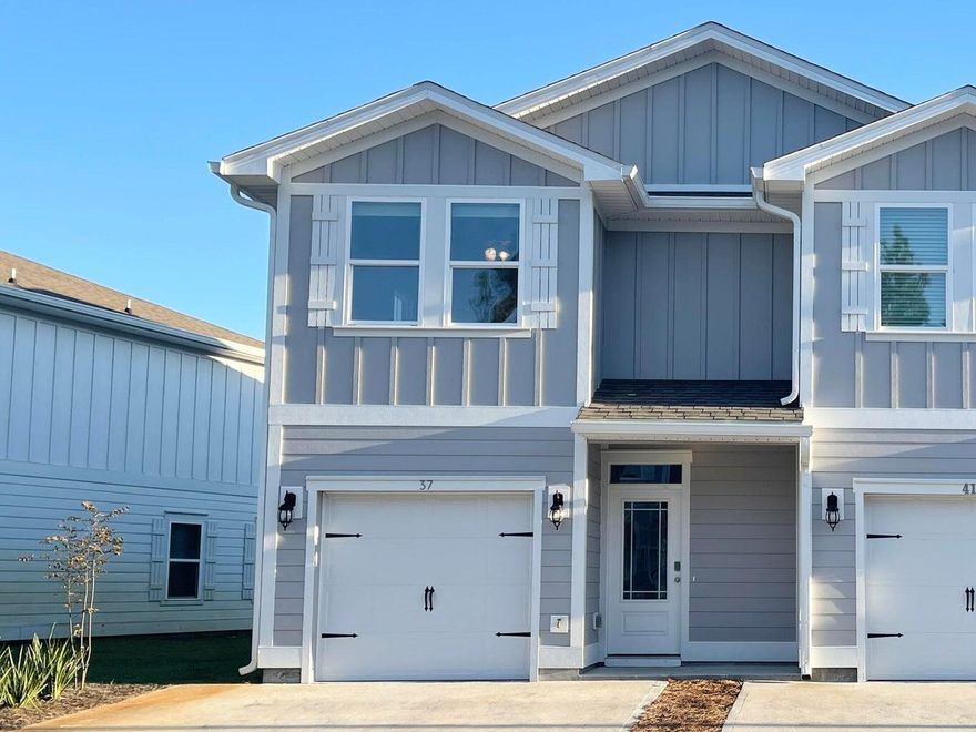 3.69% VA assumable mortgage rate with approved buyer.   Pines offers a convenient ownership opportunity with association dues covering  grounds, landscaping, plus exterior home maintenance and insurance.  This recently constructed community offers the ideal location for not only full time living, but also second home or an investment opportunity for either short or long term rental of your property.  The front entry door welcomes you into your homes foyers space where you'll find the door to your one car garage as well as a half bath.  Open concept living, dining, and kitchen offers easy furnishing placement and the end unit placement of this home keeps the space bright with additional natural light.  Upstairs offers a master suite, 2 additional bedrooms with a shared bath and laundry.