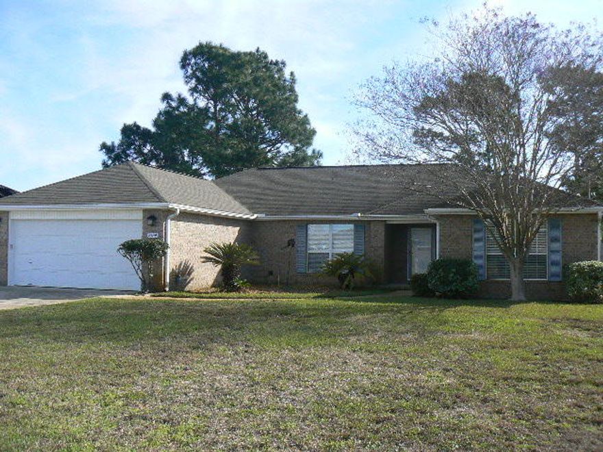 All brick 4 bedroom split plan, 2 bath home - close to shops, schools, sports complex, the Gulf Intracoastal Waterway and Navarre Beach. High vaulted ceilings in large, open concept living/dining/kitchen. Kitchen includes center island, abundant cabinetry, pantry, desk and bright breakfast area. Master bath includes garden tub, separate shower and walk-in closet with built-in shelving. Three additional bedrooms have nice closet space. A 14X12 screened porch provides for bug-free living on the Emerald Coast. There are sidewalks in this neighborhood! Rare BONUS: extra concrete pad added to driveway with dedicated electrical circuit will easily hold your boat or RV. Wired for security and large storage shed in private backyard round out a few of the great features of this home.