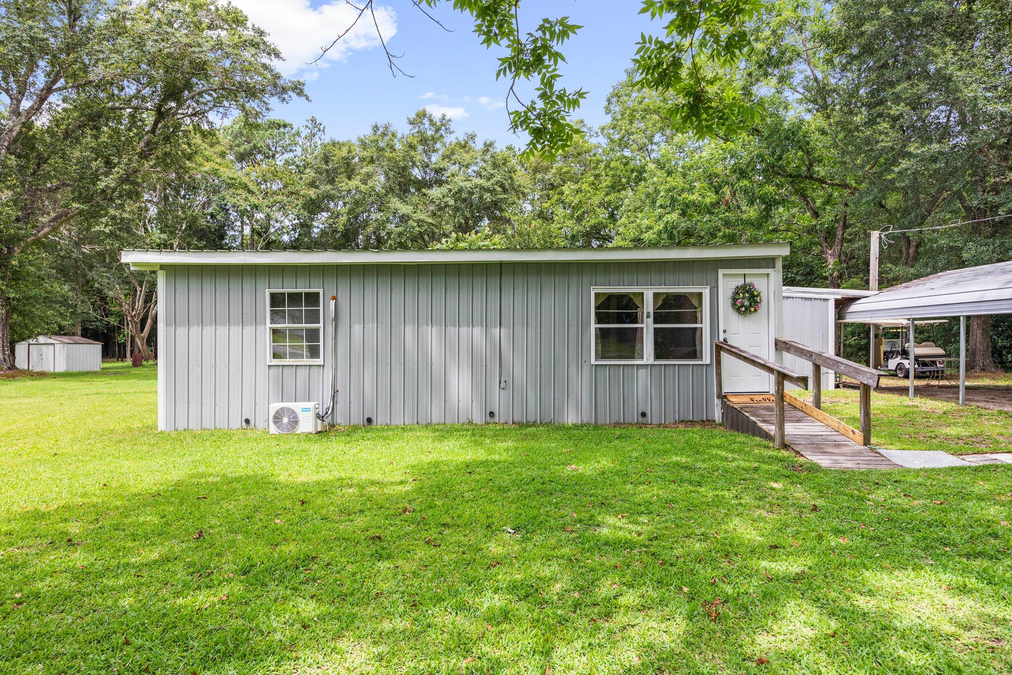 This 2012 ranch-style home offers 3 bedrooms and 1.5 bathrooms, making it a great starter home. The layout is traditional and cozy, providing a warm and inviting atmosphere. The living room features a built-in bar, ideal for entertaining or relaxing after a long day, or even a fun place to enjoy a quick meal.Situated on nearly an acre of land, the property provides ample space for outdoor activities. The yard has plenty of potential for a barbecue area, garden, or even a future pool. This home offers a peaceful retreat while still being close to schools, shopping, and parks. 25 minutes to Crestview, 15 minutes to Florala, 50 minutes to Eglin AFB and 1 hour to Destin beaches.Golf cart sold separately. Roof 2012, HWH's 2012/2014, Propane stove and heater, 2 mini splits 2023