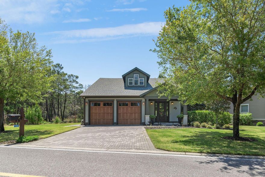 Graced by natural beauty and designed for effortless living, this affordable four-bedroom, three-bathroom home in the exclusive gated community of Wild Heron offers a rare opportunity to enjoy life on Florida's largest coastal dune lake. Positioned along a quiet stretch backing to green space, this craftsman-style residence offers a serene escape with an open floor plan, inviting outdoor spaces and resort-level amenities just steps away. The first floor features a spacious sitting room that opens into a light-filled living and dining area with hardwood floors and refined finishes throughout. The kitchen is complete with granite countertops, wood cabinetry and a large island that flows easily into the living space--ideal for casual entertaining.  A generously sized primary suite includes a dual vanity with soaking tub and tiled walk-in shower, private porch access and a walk-in closet. An additional bedroom and full bathroom complete the main level. Upstairs, two guest bedrooms share a well-appointed bath with dual vanities and a tiled tub-shower combo, offering space and comfort for visitors or family. Out back, enjoy quiet mornings or evening cocktails on the covered porch, overlooking a deep yard framed by mature pines and glimpses of the award-winning Shark's Tooth Golf Course. The home is move-in ready and impeccably maintained, with light use as a second home, while leaving room for personalization with your preferred finishes. Wild Heron is an Audubon Silver Signature Sanctuary, with over 200 acres dedicated to preservation and another 187 acres home to the Shark's Tooth Golf Course, which along with the tennis courts are now part of the WaterSound Club membership. Amenities include a lakeside boathouse stocked with kayaks and paddleboards, a resort-style pool and hot tub, fitness center, playground, new dock and private marina (for lease), walking trails and access to private beach launches via Lake Powell. Community events, farmers' markets and family-friendly gatherings foster a rare sense of connection in this non-rental neighborhood. Just minutes from 30A, Alys Beach and Pier Park, this exceptional retreat offers the very best of coastal livingsecluded, secure and surrounded by nature. Measurements are approximate. Buyer should verify all data and dimensions if important.