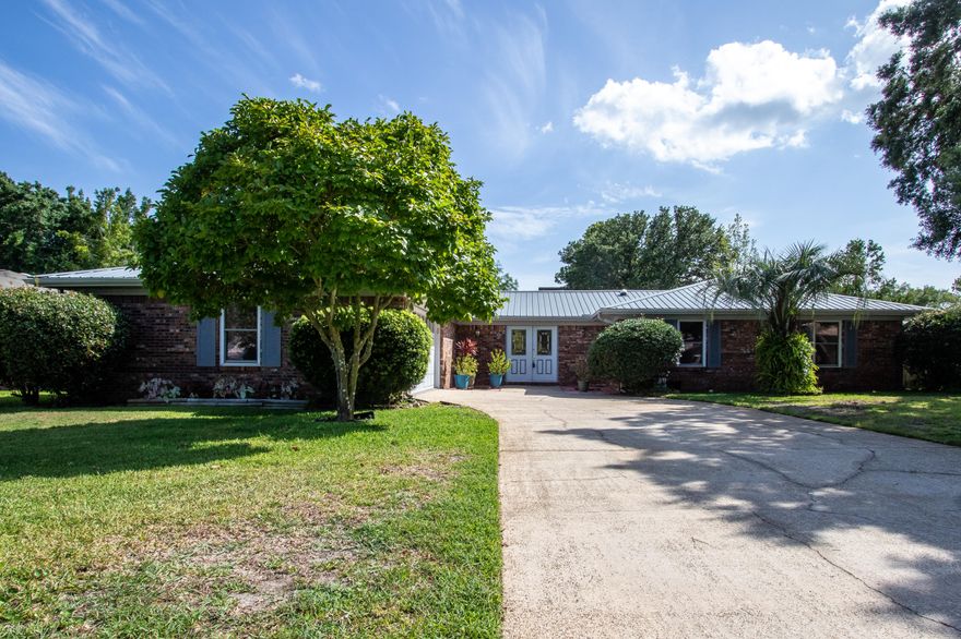 PRICE REDUCTION! This beautiful 4/2 home located on a quiet and much-desired street in Lake Lorraine. The home features a vibrant and custom feel with laminate wood flooring. The kitchen has an abundance of refaced cabinets with all new hardware. The master suite has a private bathroom with a custom walk-in shower and double shower heads, double closets, and a private Florida room off the master suite. Two living/family rooms and dining area offer plenty of space for family or entertaining, while both bathrooms are very roomy and have a unique touch to them. Additionally, the large laundry room has a utility sink and is adjacent to the garage with lots of built-in shelving and storage. You'll enjoy this home inside, as well as in the spacious and well-manicured backyard with a covered pati