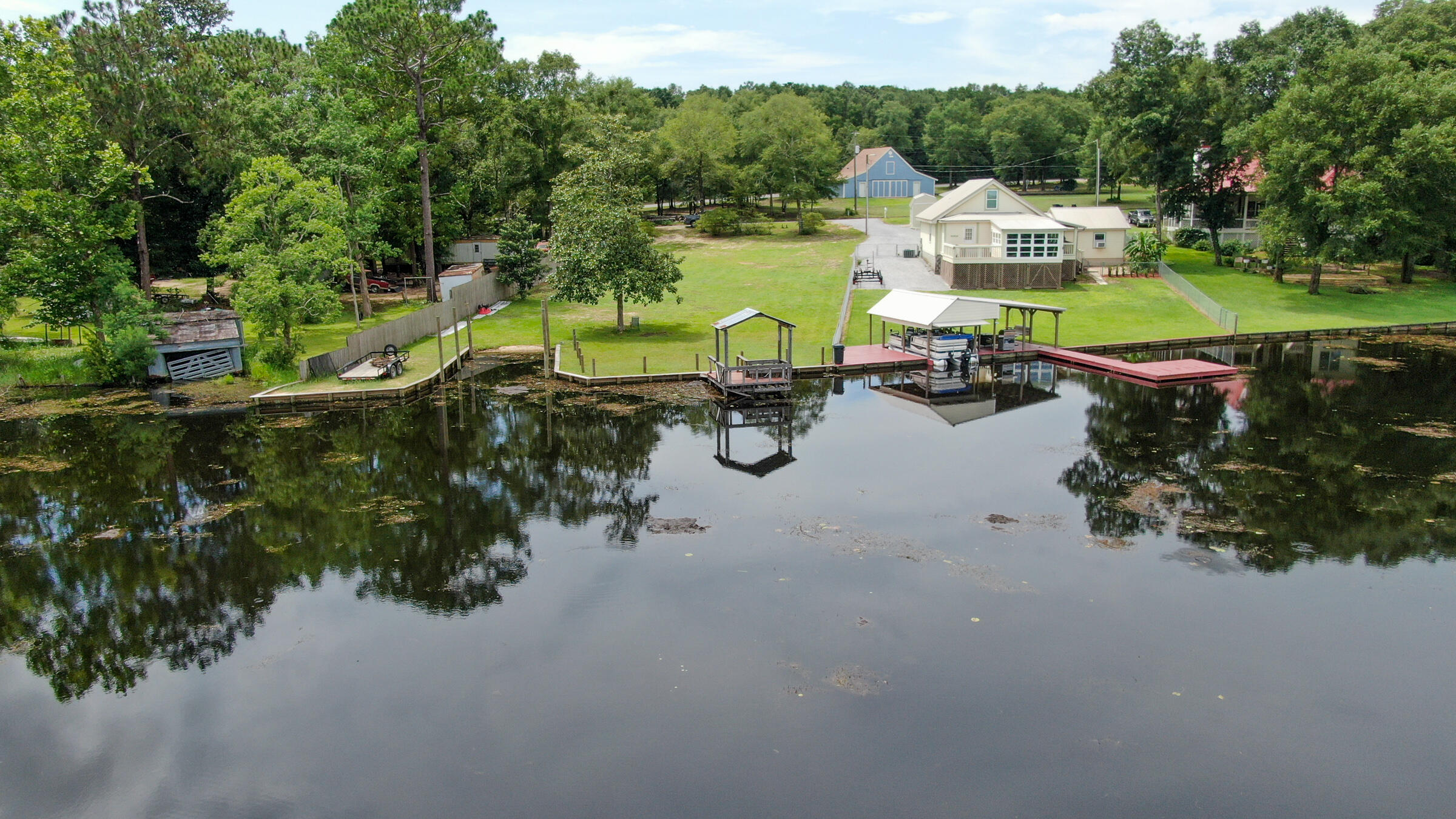 Remarkable opportunity to own a ready-to-build waterfront lot on Lake Juniper. This cleared site also has 1) electric ready to go 2) septic permit ready to go 3) water tap paid, 4) dock and 5) a boat launch and 6) even a brand new seawall! Lake Juniper is a state managed 665 acre lake full of bass, bream and catfish. Located on a paved road with a gentle slope to the water and located just 5 minutes north of downtown DeFuniak Springs and 35 minutes north of the sugar white sand of Walton County beaches. County public park with boat launch, picnic tables, etc is just around the corner. Build or place your manufactured home. Just don't wait too long or it will be like that fish story...the one that got away!